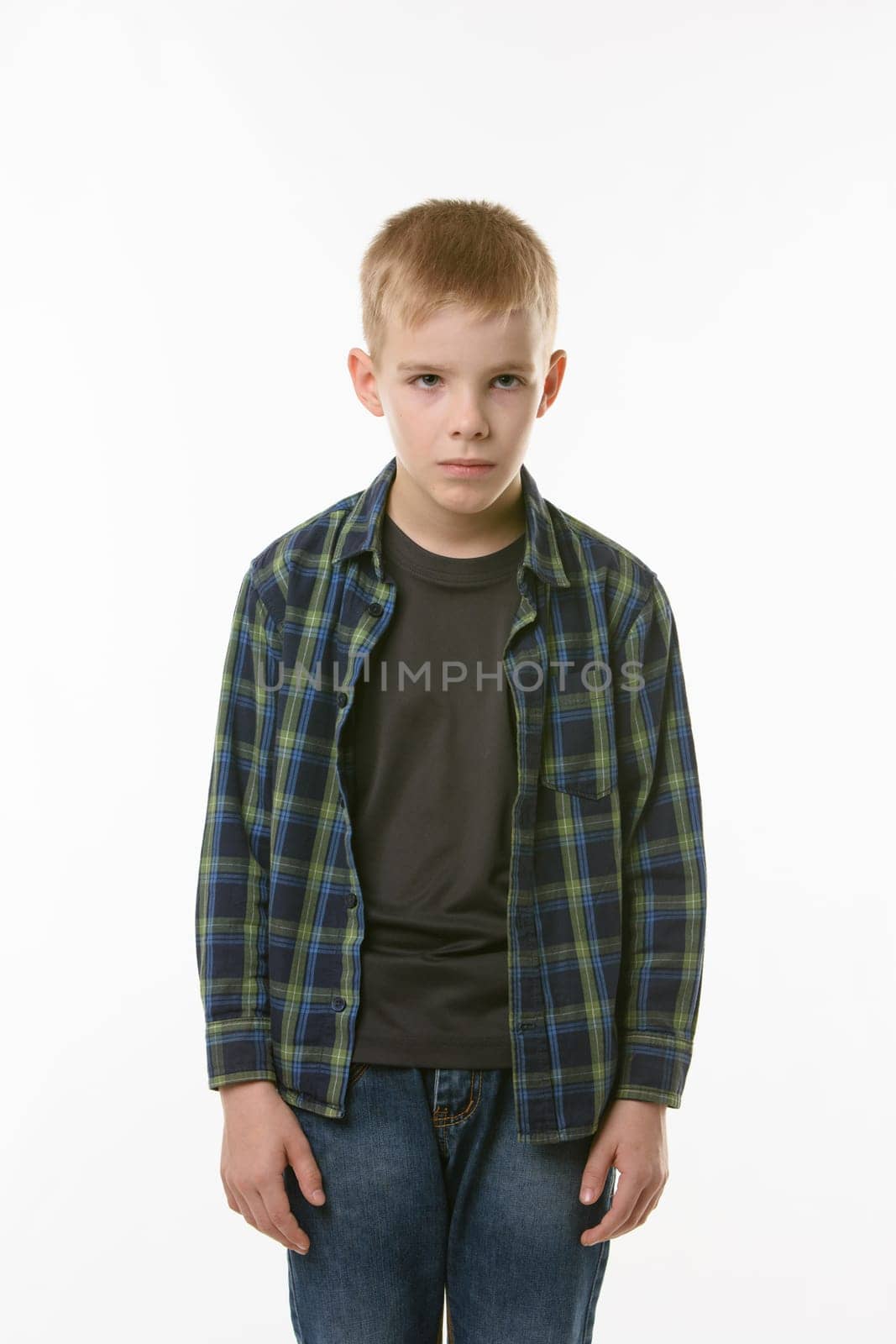 Portrait of an annoyed boy of ten years on a white background
