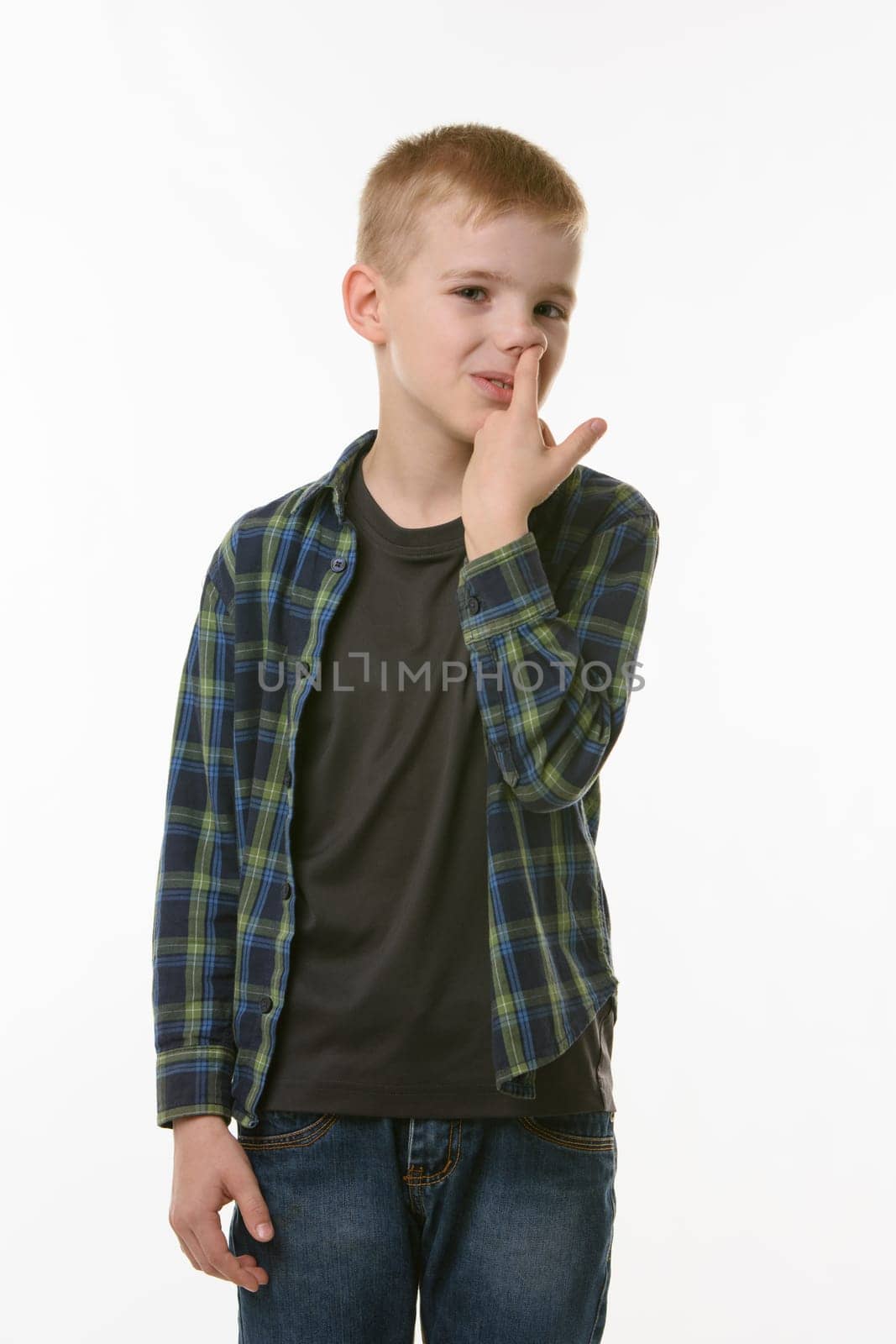Boy picking fingers in nose isolated on white background