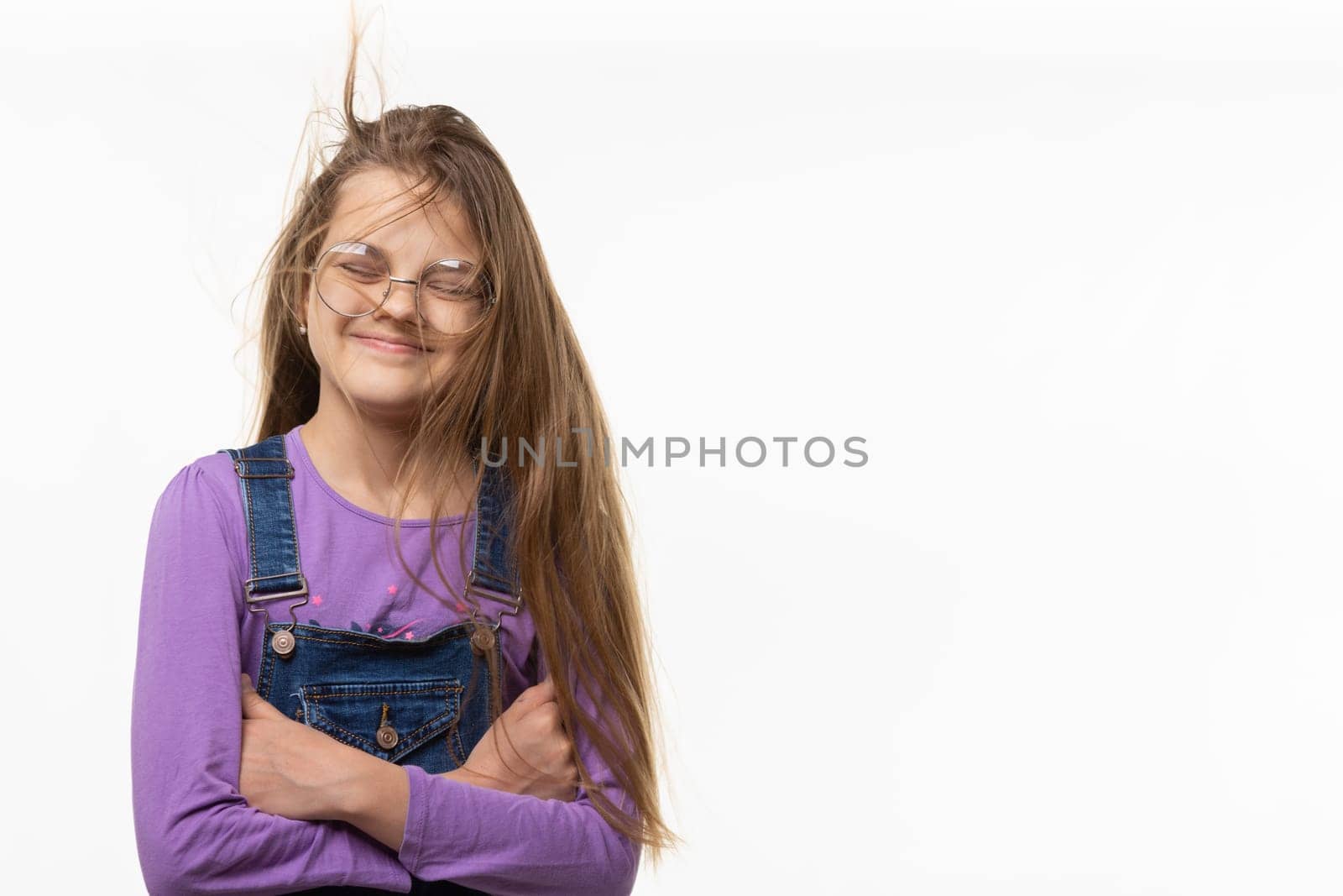 A girl of eleven from the wind tangled in long hair