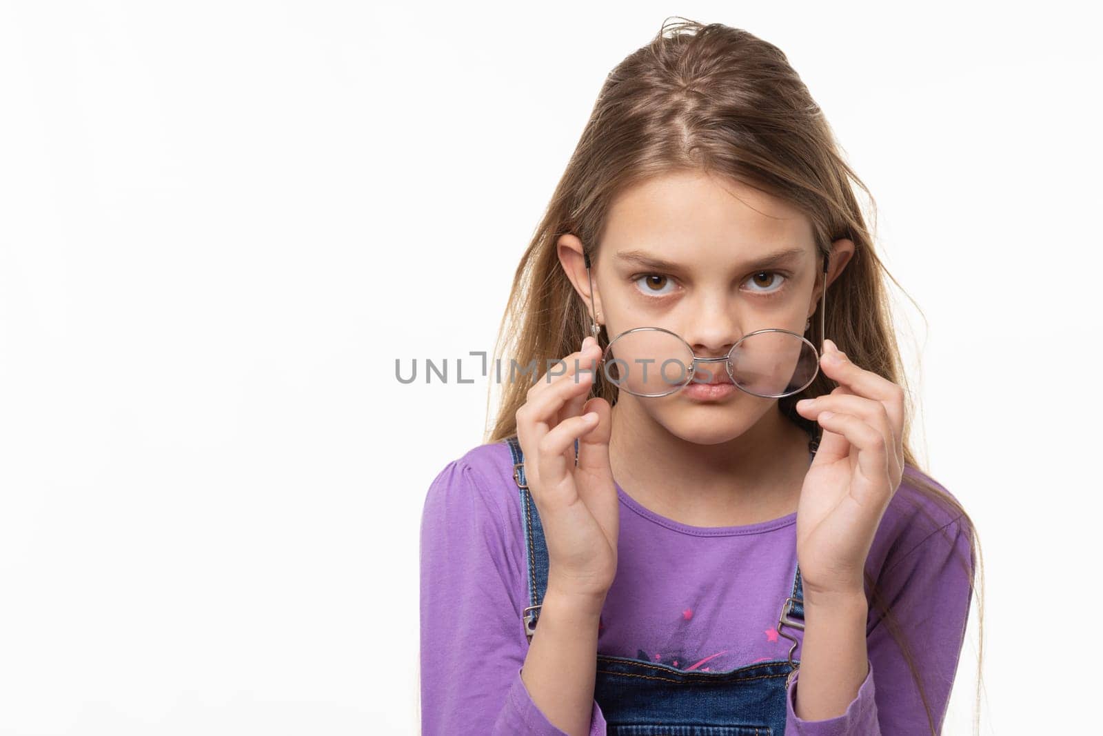 Teen girl takes off glasses isolated on white background