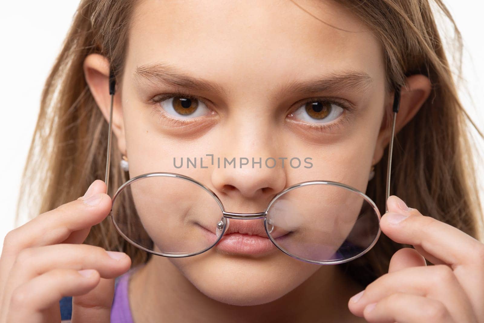 Closeup portrait of a girl who took off round glasses