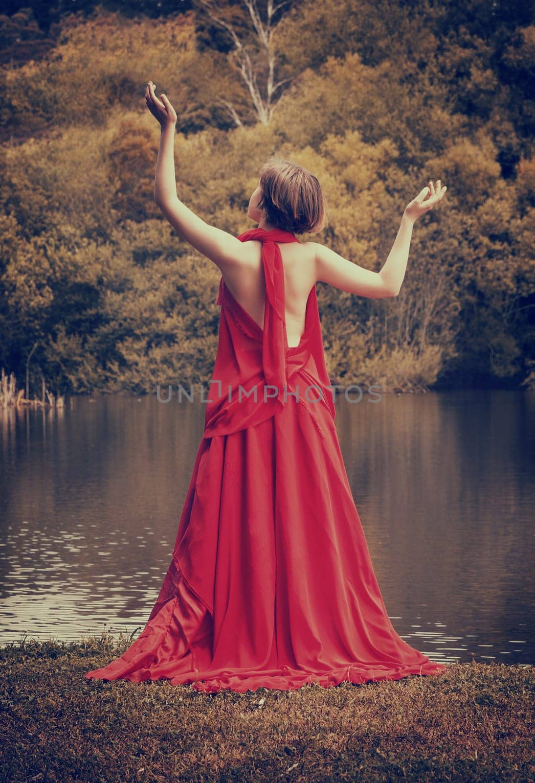 woman with beautiful dress by the lake