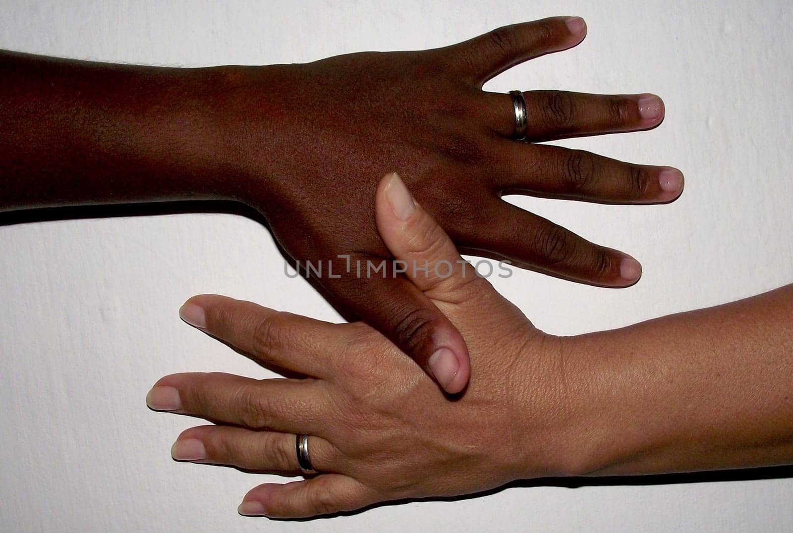 salvador, bahia / brazil - february 13, 2011: hand of black man and hand of white woman are seen together in the city of Salvador..