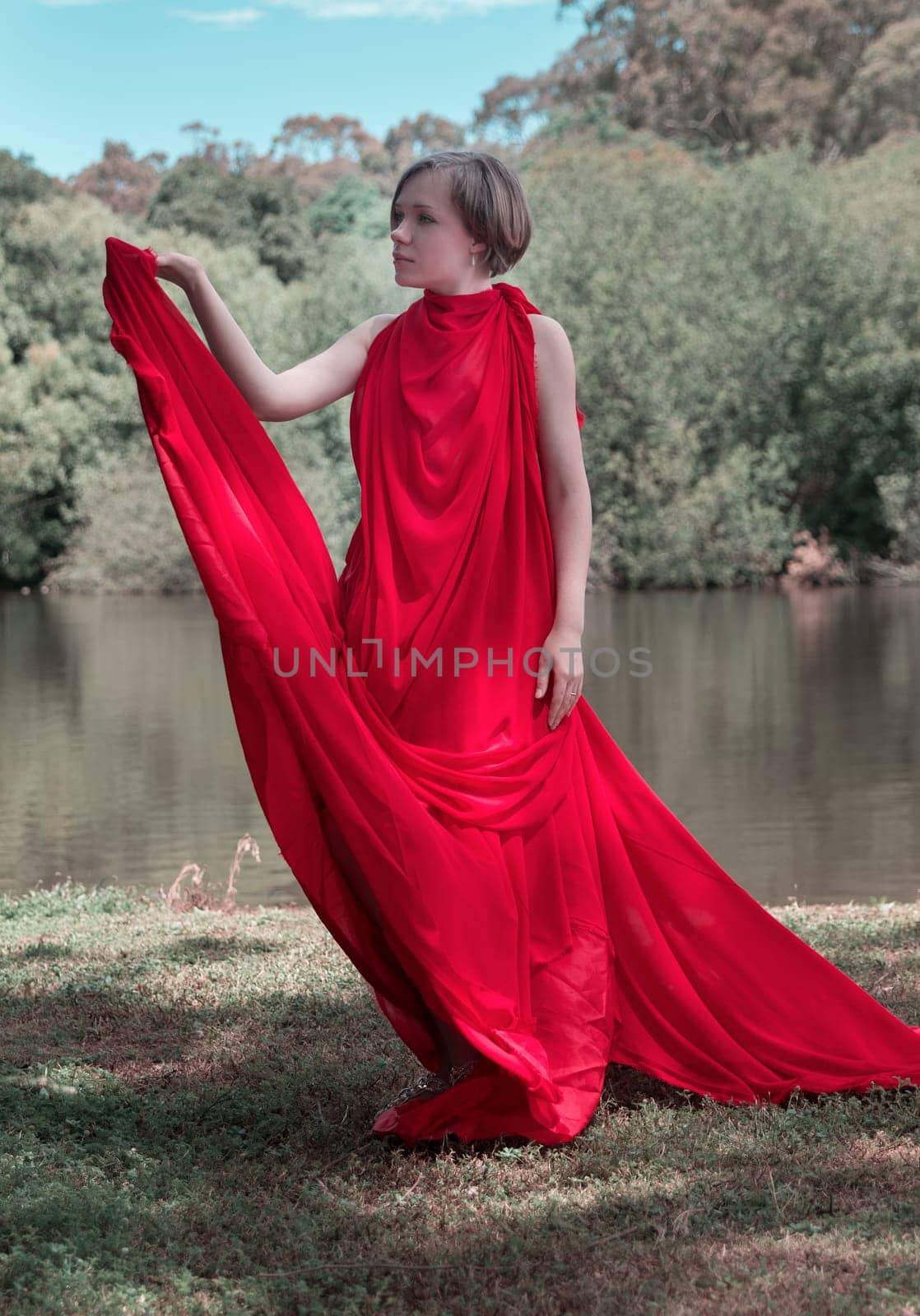 woman with beautiful dress by the lake