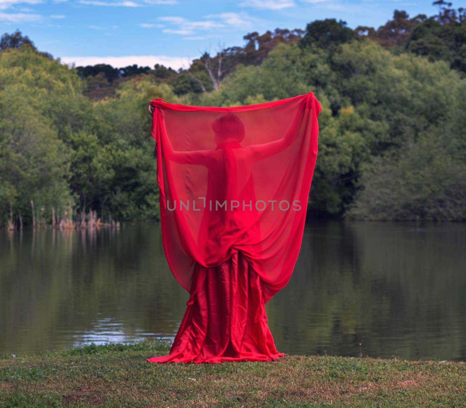 woman with beautiful dress by the lake