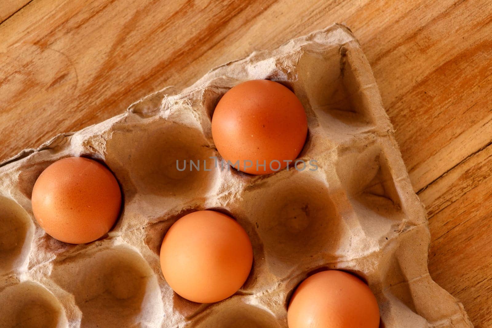 Thirty brown chicken eggs in a cardboard tray packaging. Raw fresh hen eggs in a carton box. Egg pattern background for easter, breakfast, cuisine. Top view