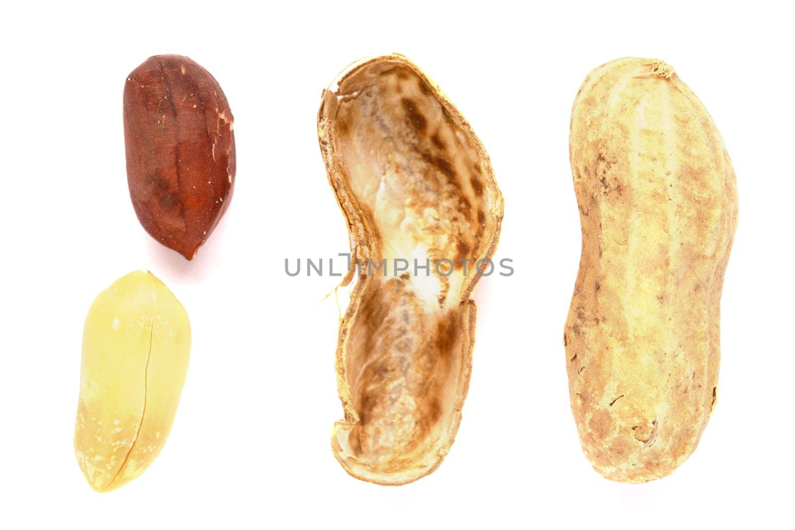 Some peanuts with the shell next to them on a white background