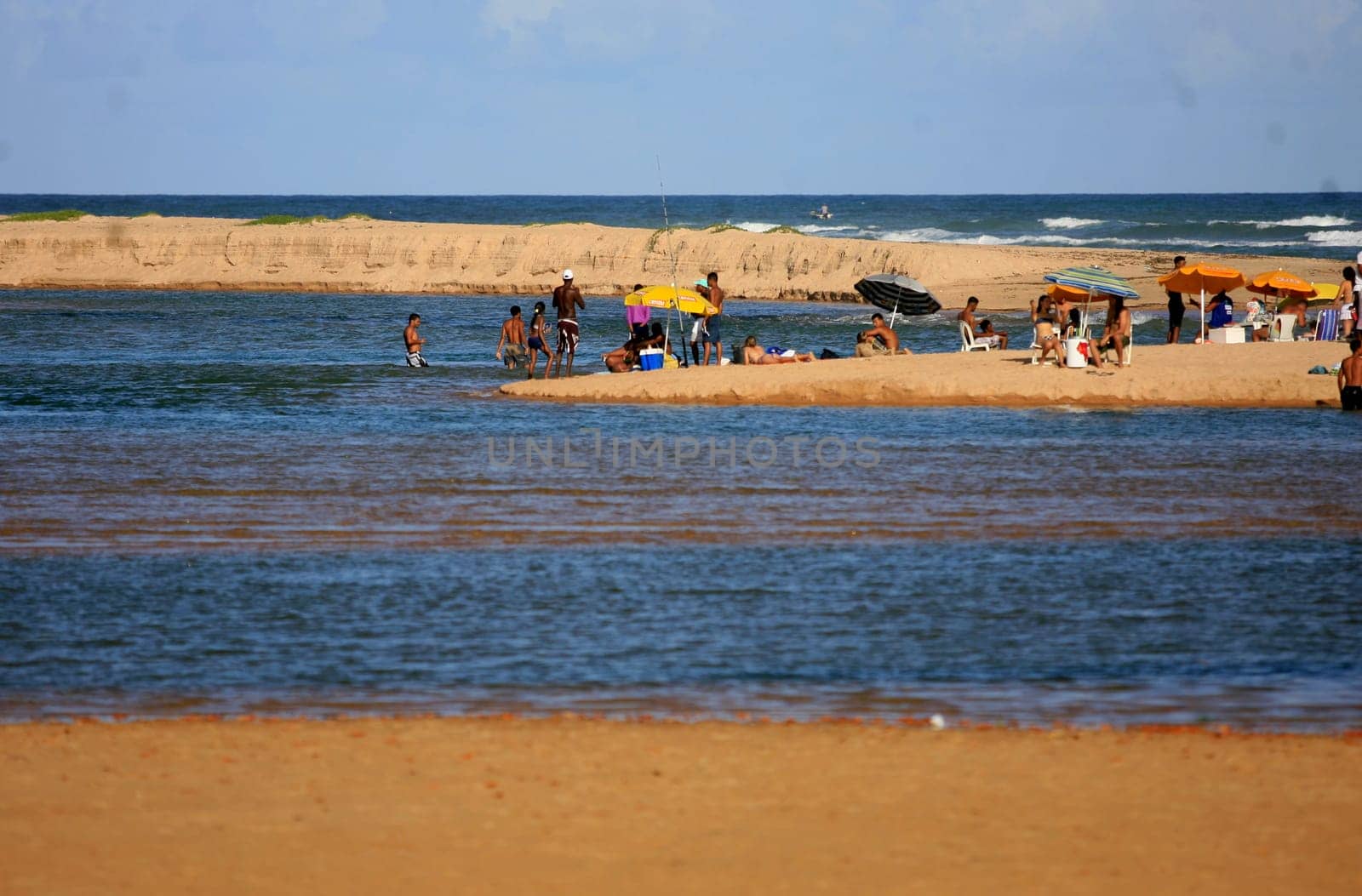 lauro de freitas, bahia / brazil - january 16, 2017: people are seen at the mouth of the Joanes River in the neighborhood of Buraquinho, in the city of Lauro de Freitas.