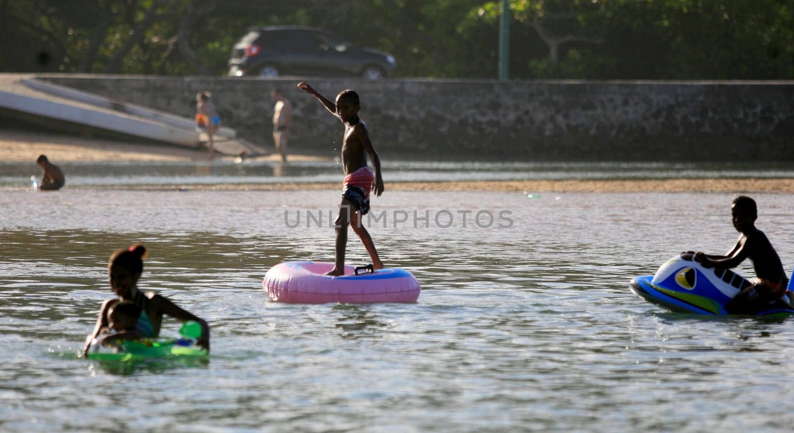 lauro de freitas, bahia / brazil - january 16, 2017: people are seen at the mouth of the Joanes River in the neighborhood of Buraquinho, in the city of Lauro de Freitas.
