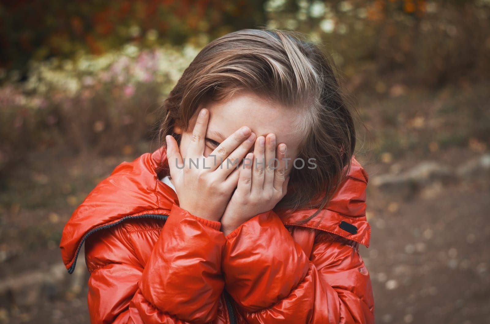 pretty girl portrait in the park playing in hiding