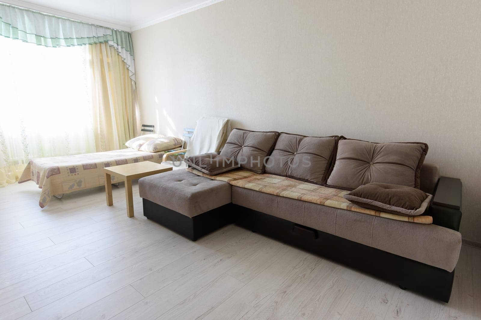 Bedroom interior with large sofa and bed