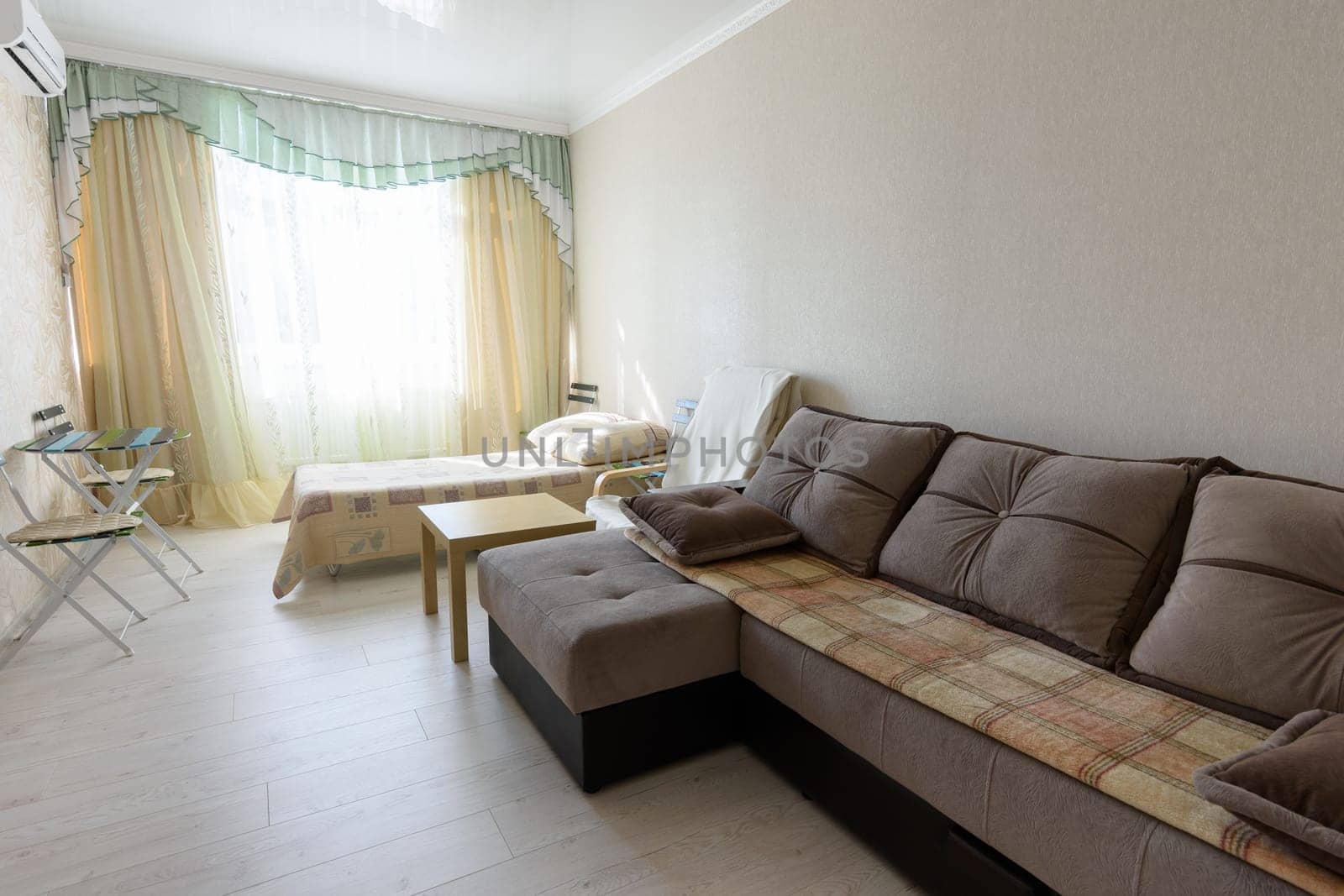 The interior of the bedroom in the apartment with a large sofa