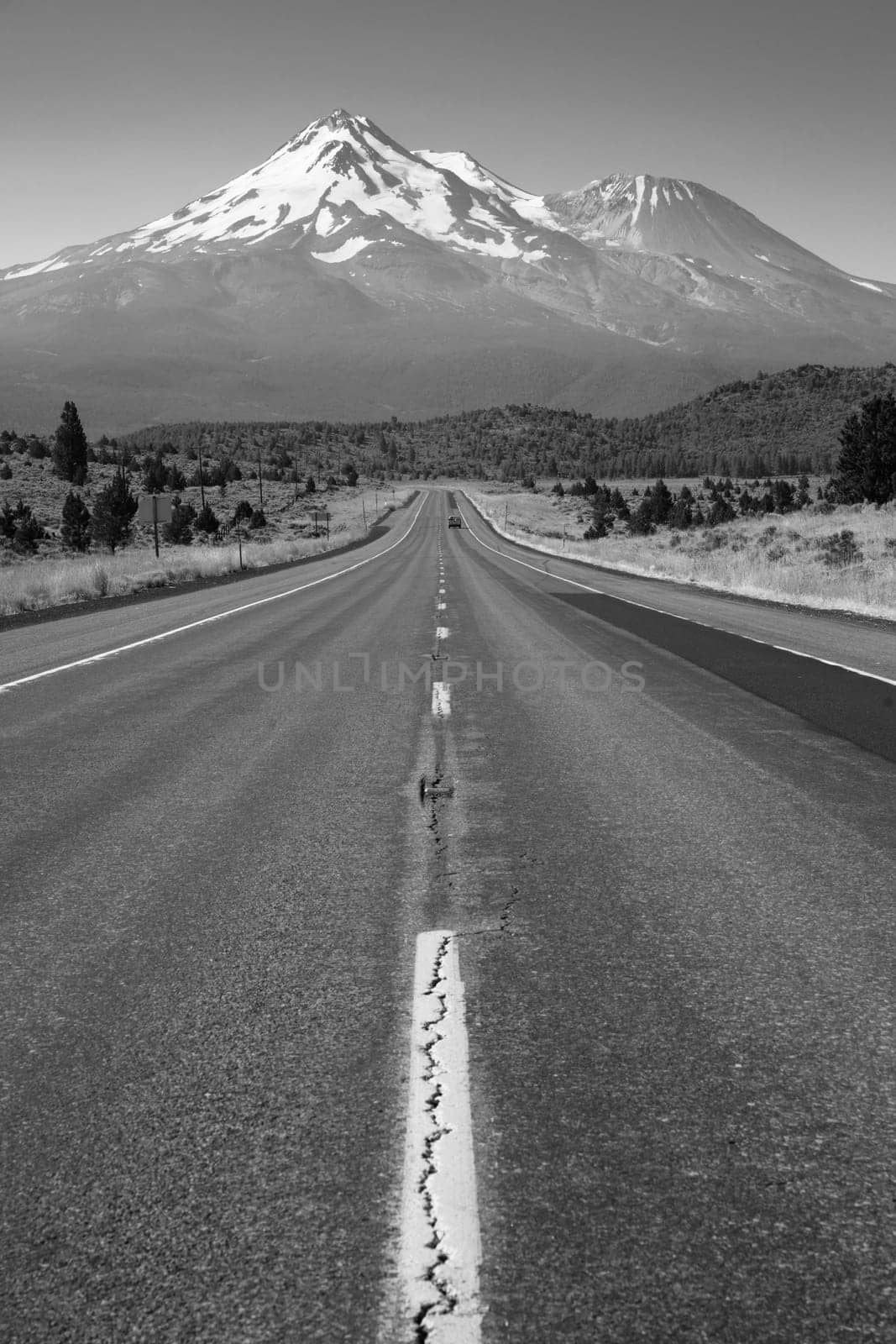 Two lane road heads west across California Mountain Landscape