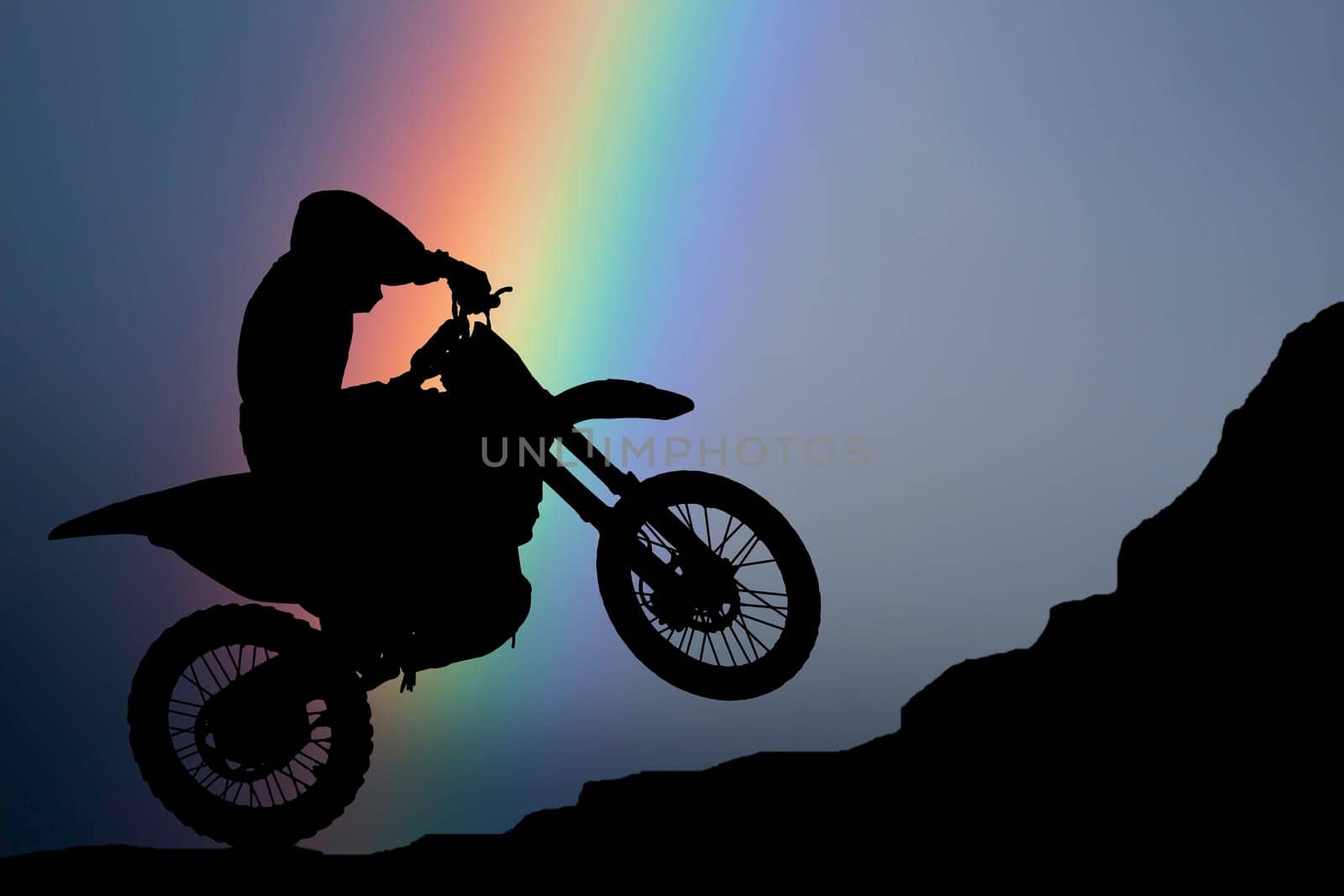 Motocross - silhouette with colorful rainbow in the sky