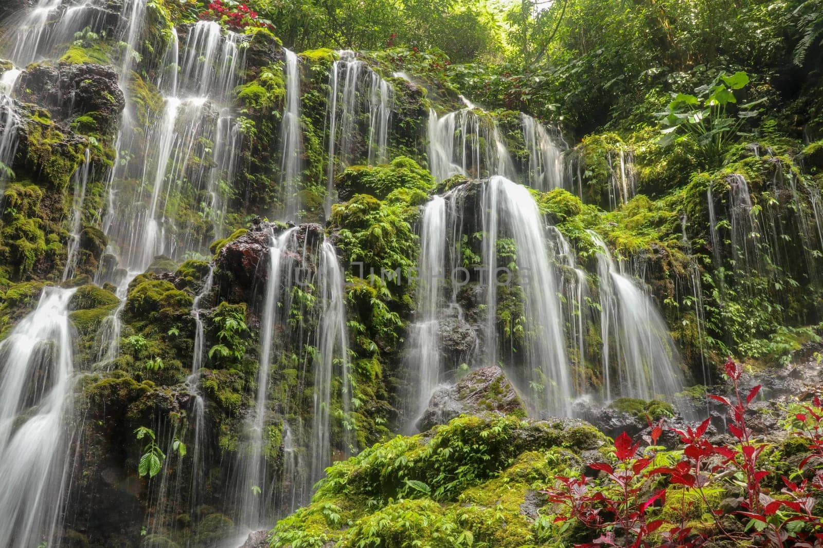 Banyuwala waterfall in Bali island, Indonesia. Scenic waterfall high in the mountains. Having fun in the wild nature. Waterfall in tropical jungle. Bali Travel Concept. Lifestyle. Travel photography.