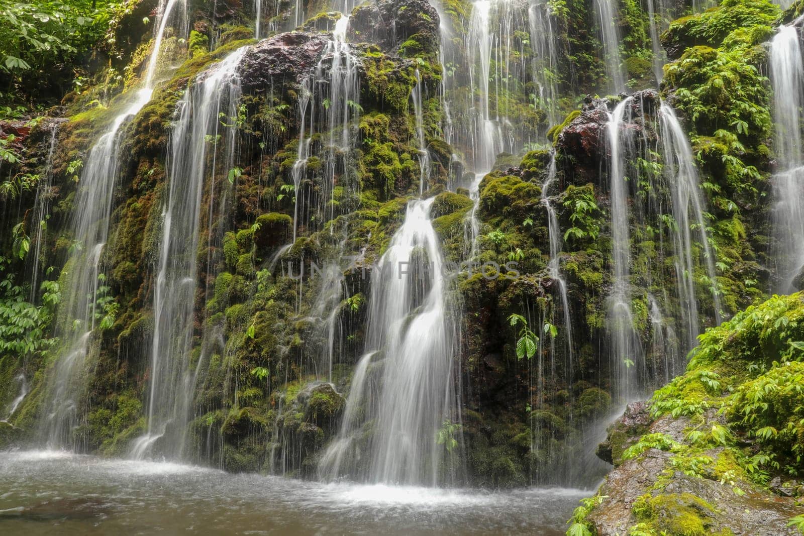 Banyuwala waterfall in Bali island, Indonesia. Scenic waterfall high in the mountains. Having fun in the wild nature. Waterfall in tropical jungle. Bali Travel Concept. Lifestyle. Travel photography.
