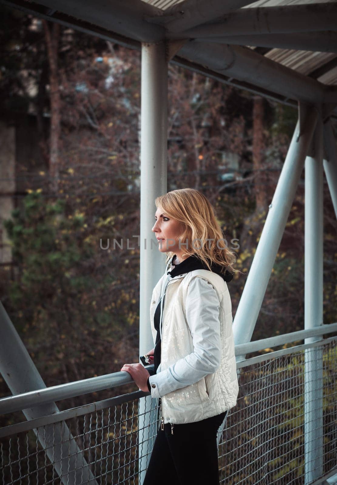Blond woman on the bridge. Autumn time