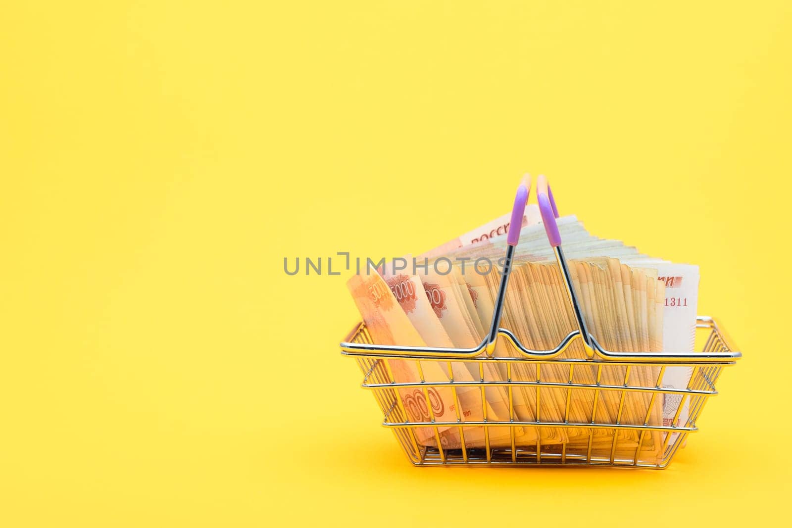 In the grocery basket lies a large bundle of five thousandth bills