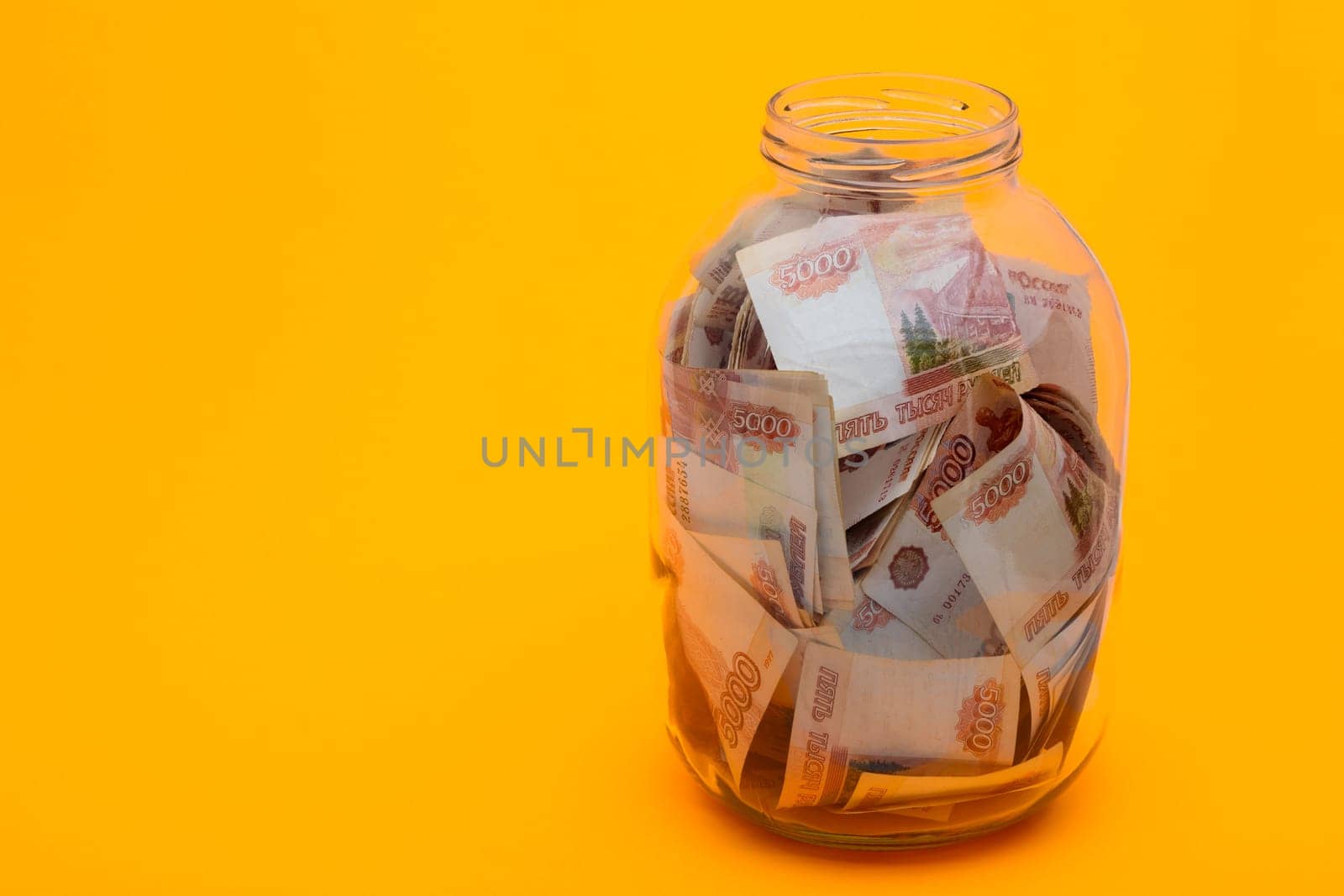 In a glass three-liter jar are five thousandth Russian bills