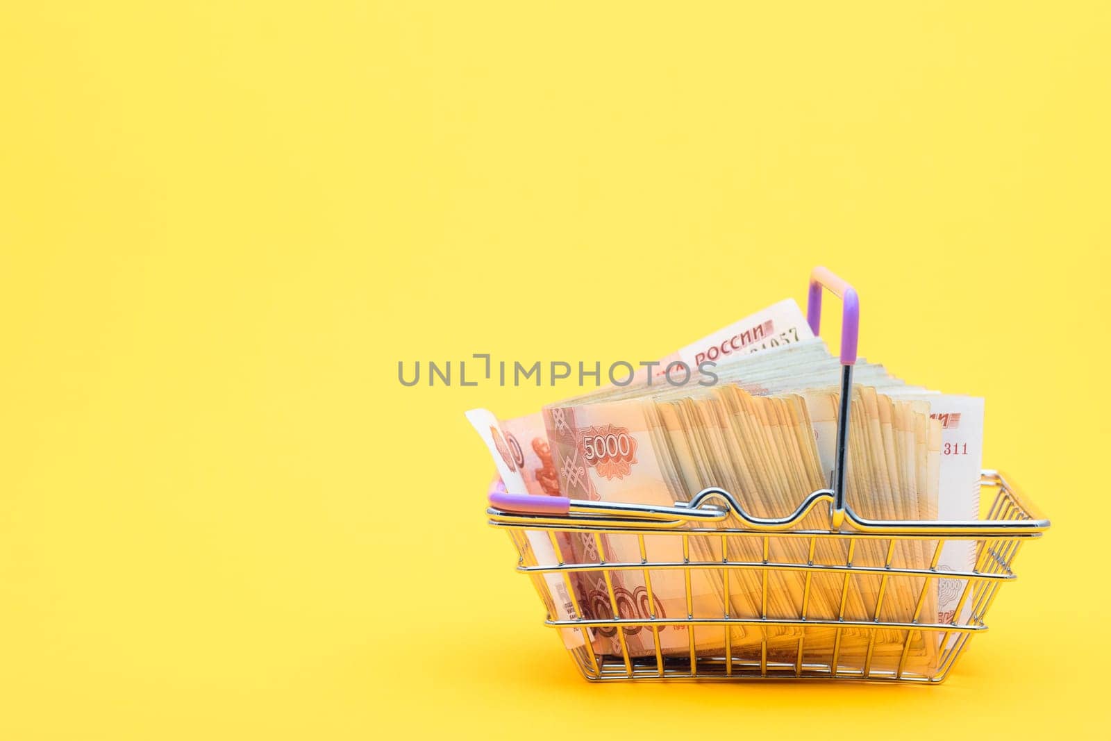 A grocery basket full of five thousandth bills