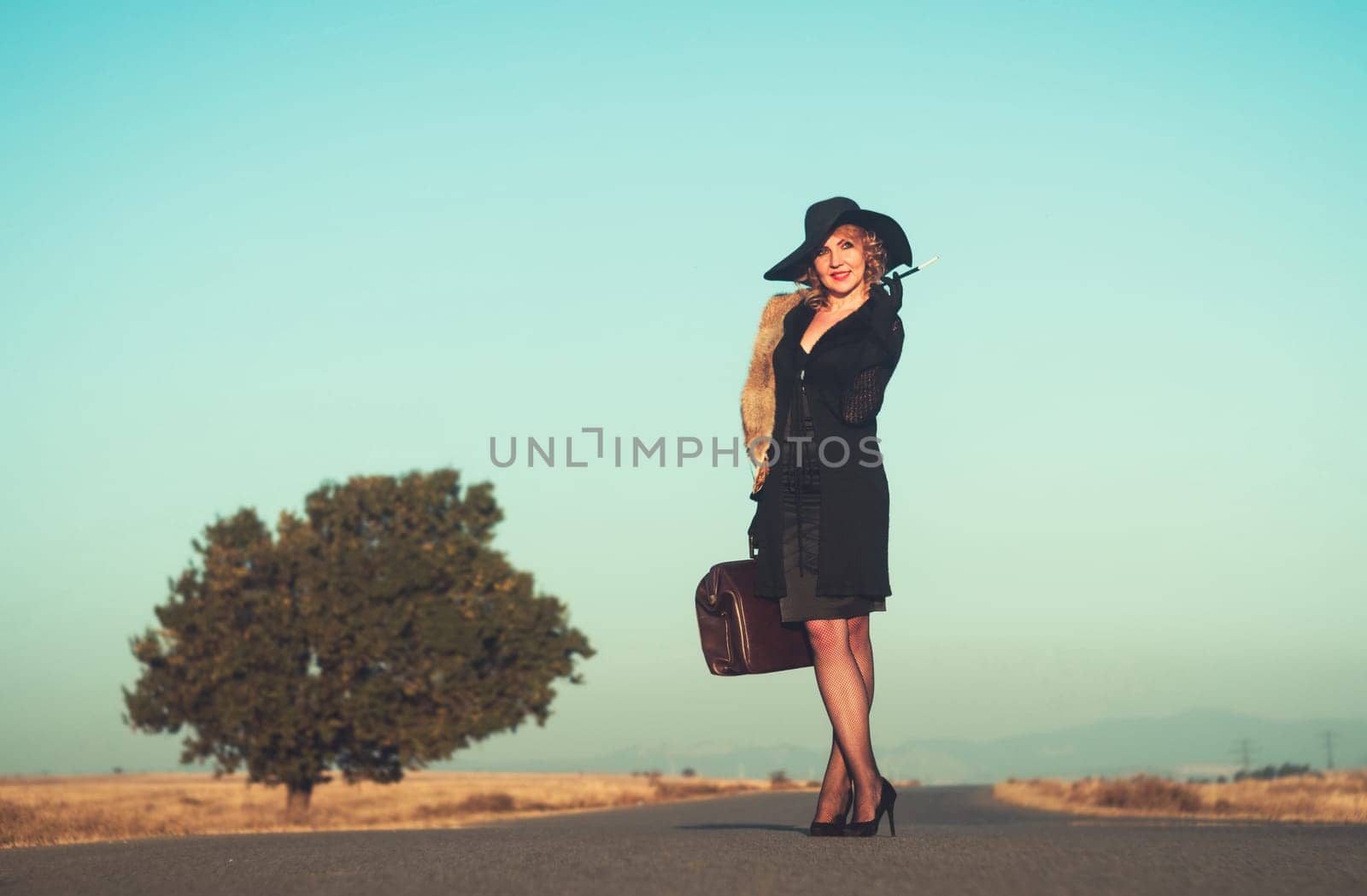 Retro beautiful blond woman portrait on road