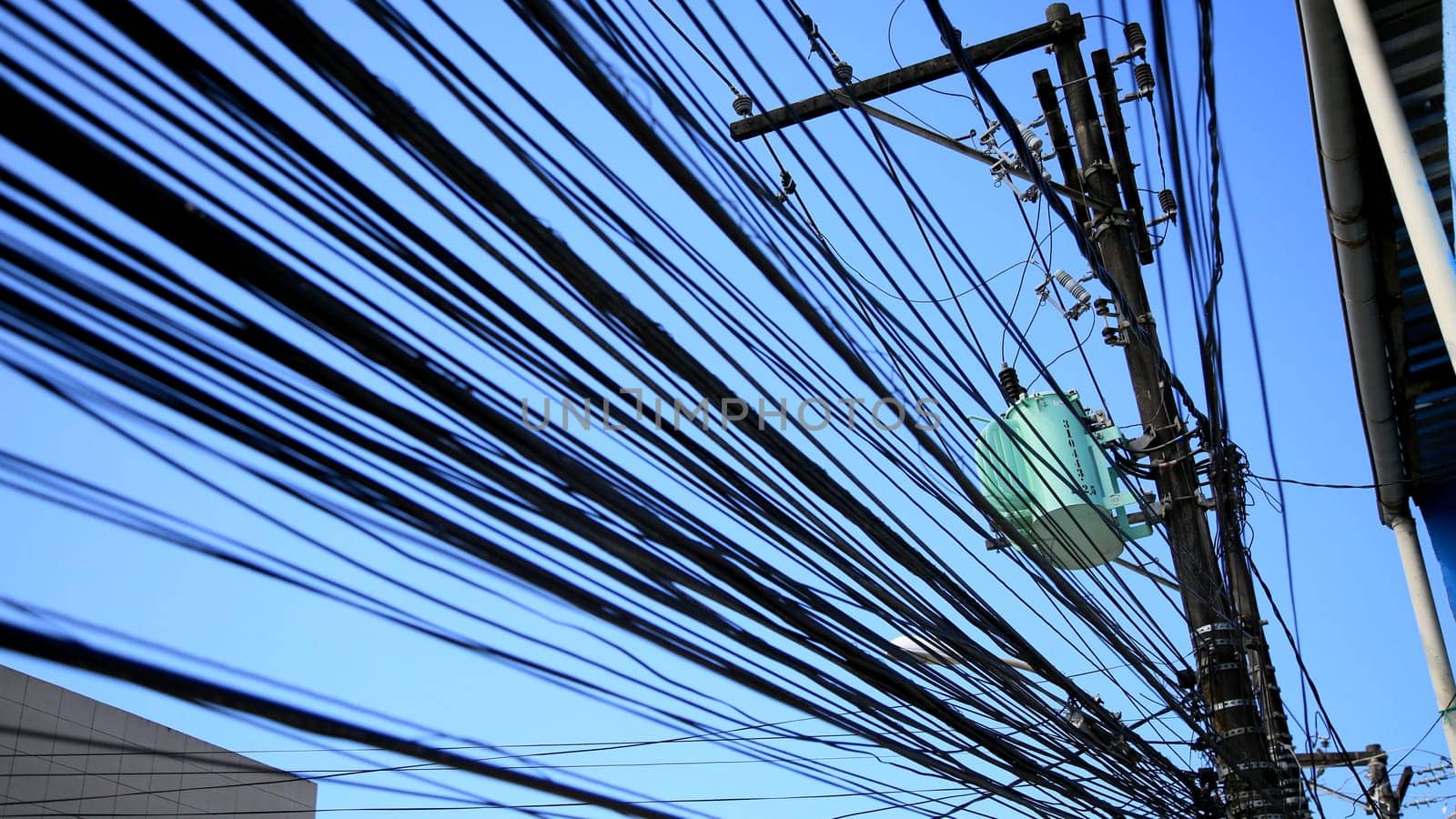 salvador, bahia / brazil - july 1, 2020: electrical network transformer is seen amidst pole wiring in the neighborhood of Pernambues, in the city of Salvador..