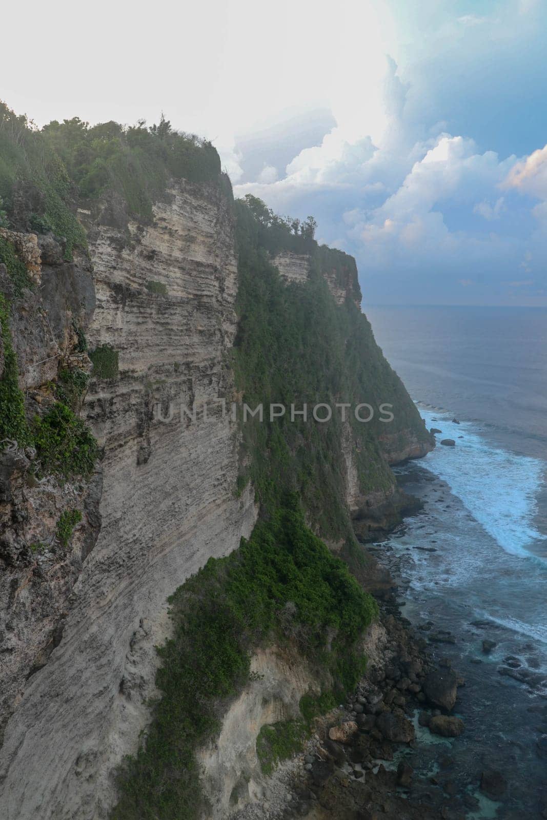 Uluwatu Temple Pura Luhur Uluwatu is a Balinese Hindu sea temple located in Uluwatu. It is renowned for its magnificent location, perched on top of a cliff. Picturesque bright cliff landscape.