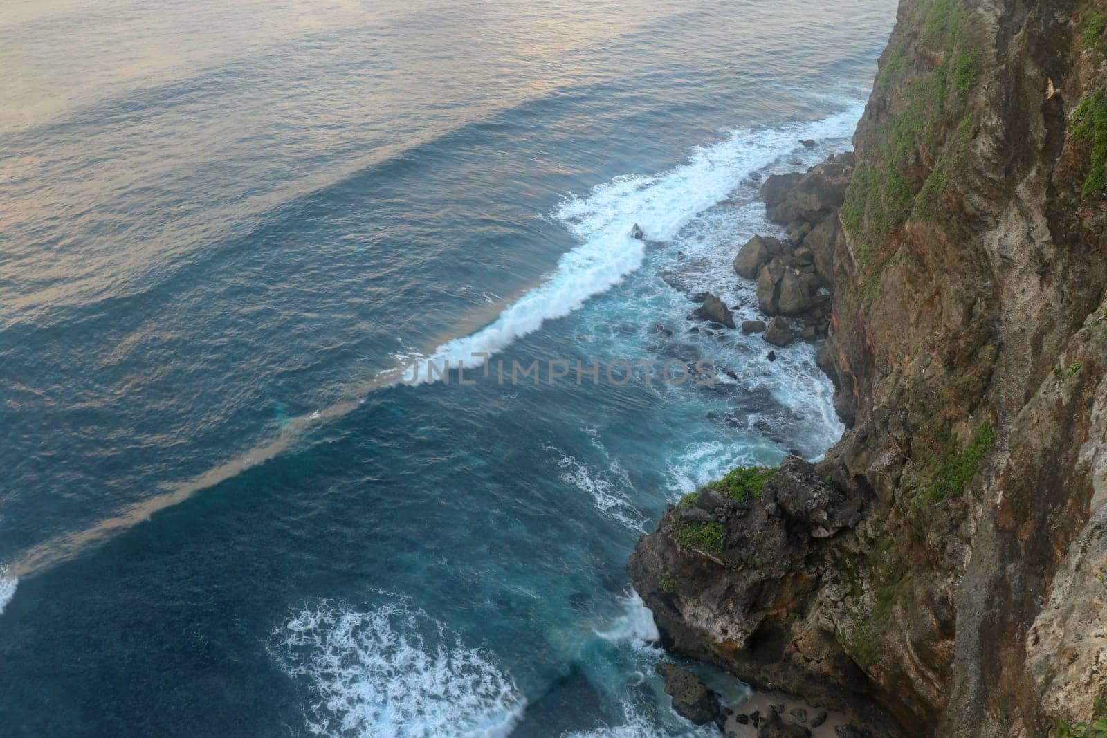 Uluwatu Temple Pura Luhur Uluwatu is a Balinese Hindu sea temple located in Uluwatu. It is renowned for its magnificent location, perched on top of a cliff. Picturesque bright cliff landscape.