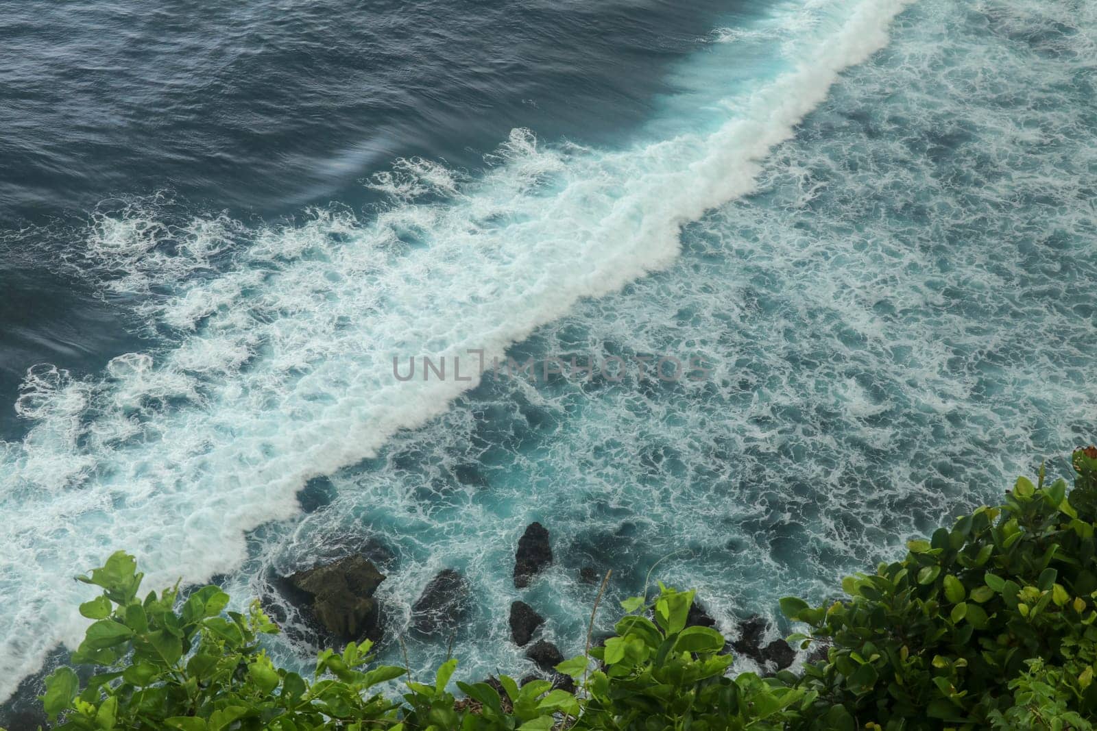 Beautiful Panoramic view of an Iconic Famous Place, Uluwatu Temple, during a vibrant summer sunrise. Amazing views at Pura Luhur Uluwatu temple in Bali Island. Nice colourful sunset with clouds.