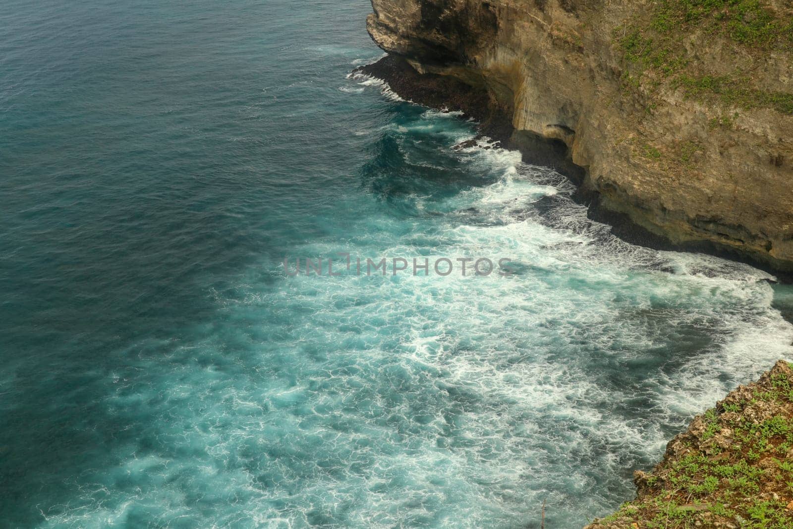 Beautiful Panoramic view of an Iconic Famous Place, Uluwatu Temple, during a vibrant summer sunrise. Amazing views at Pura Luhur Uluwatu temple in Bali Island. Nice colourful sunset with clouds.