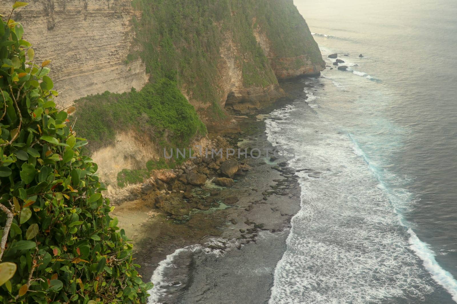 Uluwatu Temple Pura Luhur Uluwatu is a Balinese Hindu sea temple located in Uluwatu. It is renowned for its magnificent location, perched on top of a cliff. Picturesque bright cliff landscape.