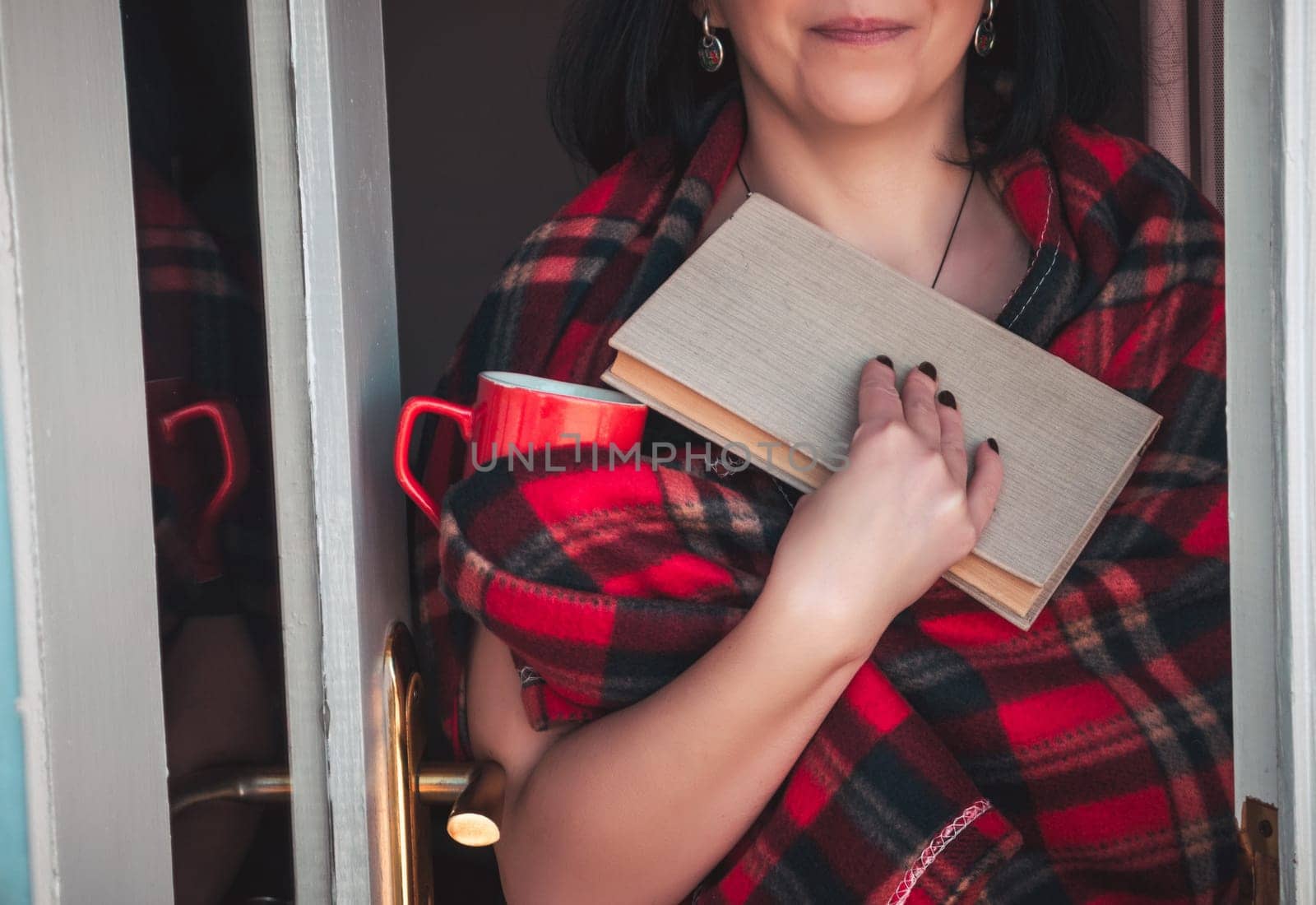 Woman on balcony with book and coffee