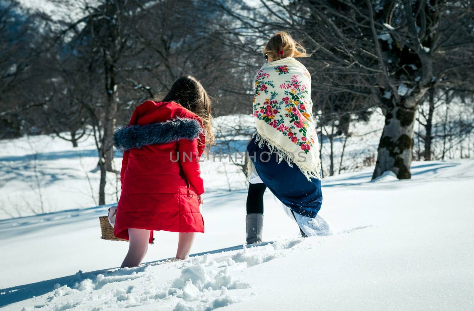 Girl with mum walking in the snow