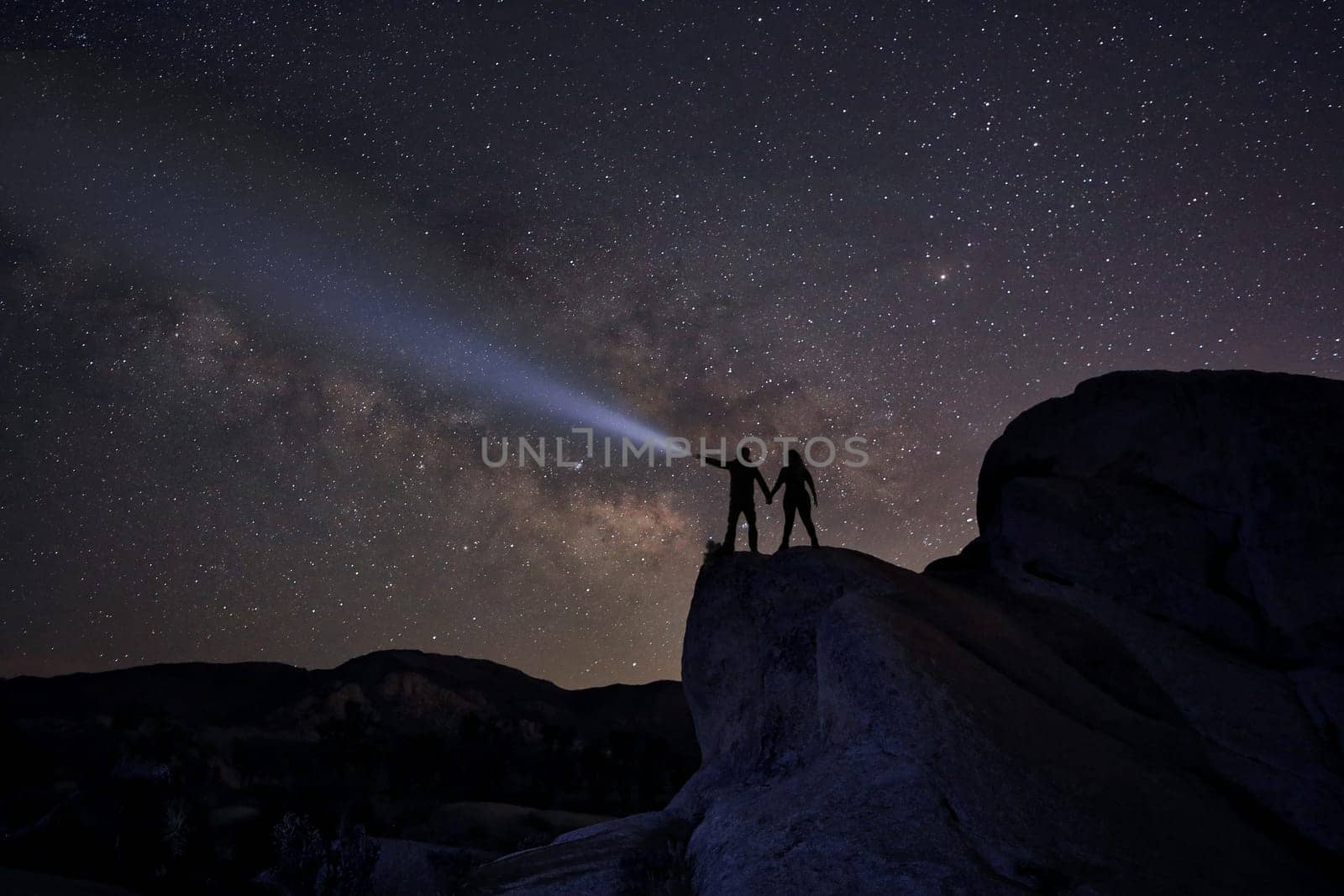 Happy Couple Silhouette Under the Stars at Night