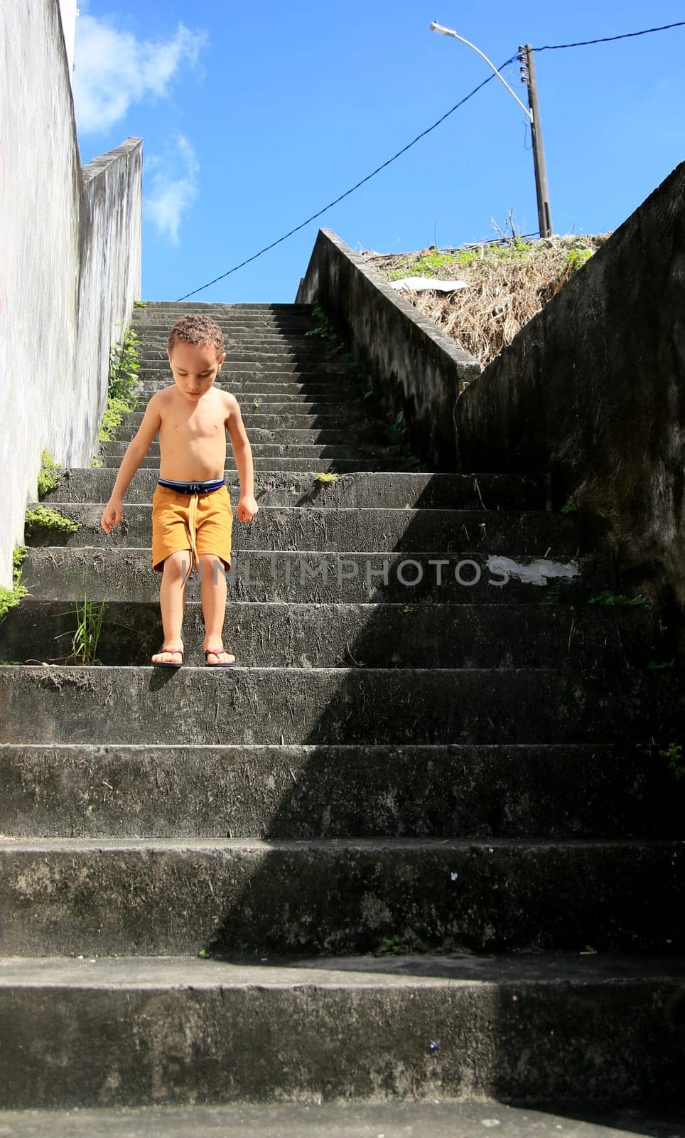 salvador, bahia / brazil - july 2, 2020: child is seen descending stairs in residential condominium in the city of Salvador....
