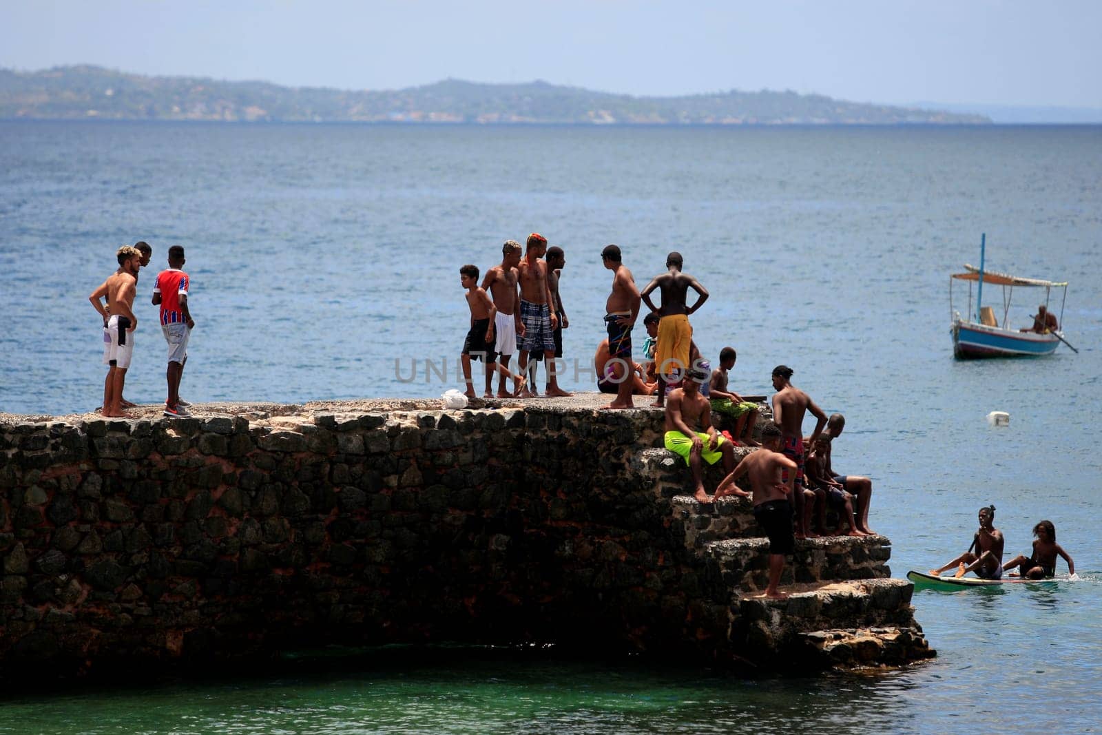 salvador, bahia / brazil - february 22, 2017: people are seen on the wall next to the fort of Santa Maria in Porto da Barra in the city of Salvador..
