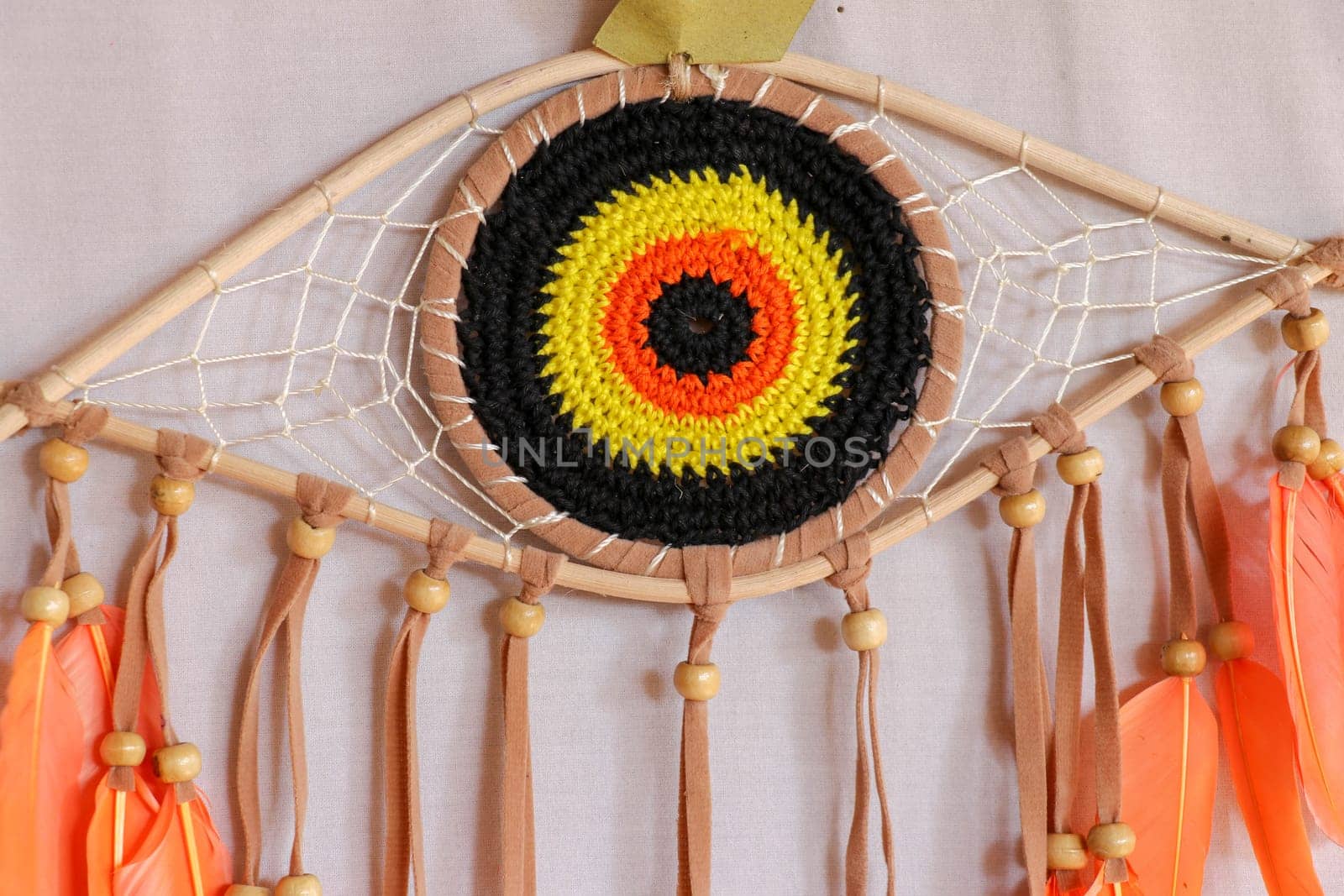 divine eye of providence dreamcatcher with colored feathers on a white background.