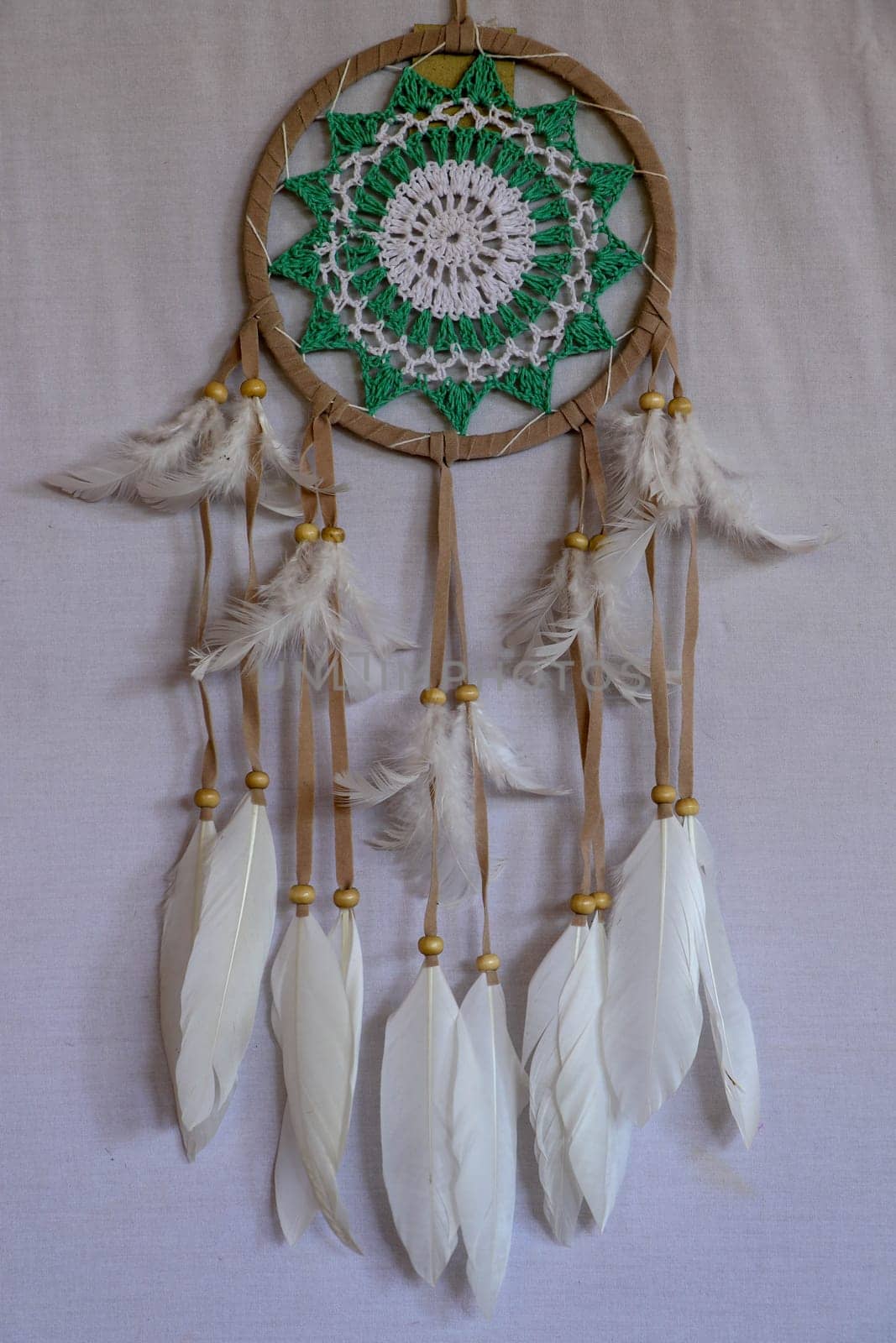 Beautiful green dream catcher on white background.