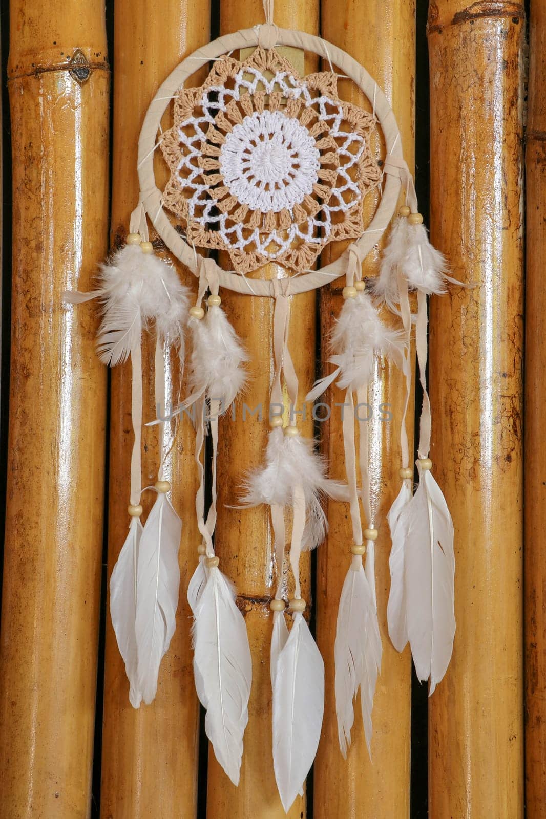 White crocheted dreamcatcher, an Indian amulet that protects the sleeper from evil spirits and diseases. Soft focus. Closeup.