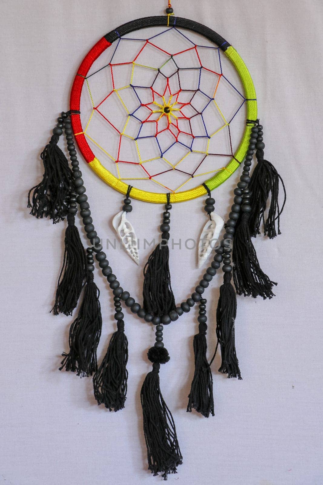 Beautiful multicolored handmade dreamcatcher with sea shells on white background.