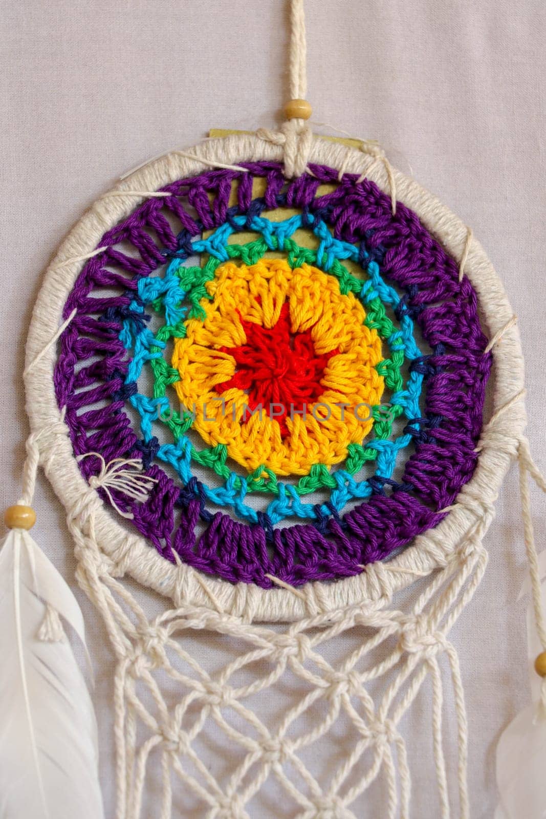 Beautiful multicolored handmade dreamcatcher on white background.