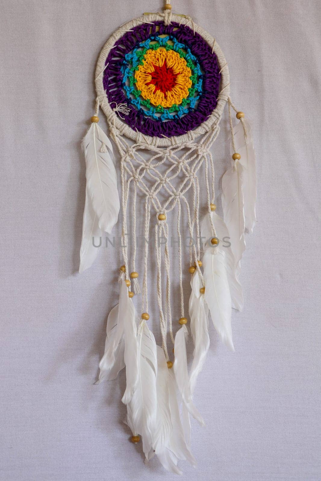 Beautiful multicolored handmade dreamcatcher on white background.