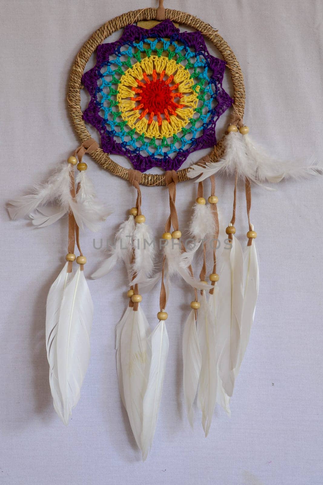 Beautiful multicolored handmade dreamcatcher on white background.