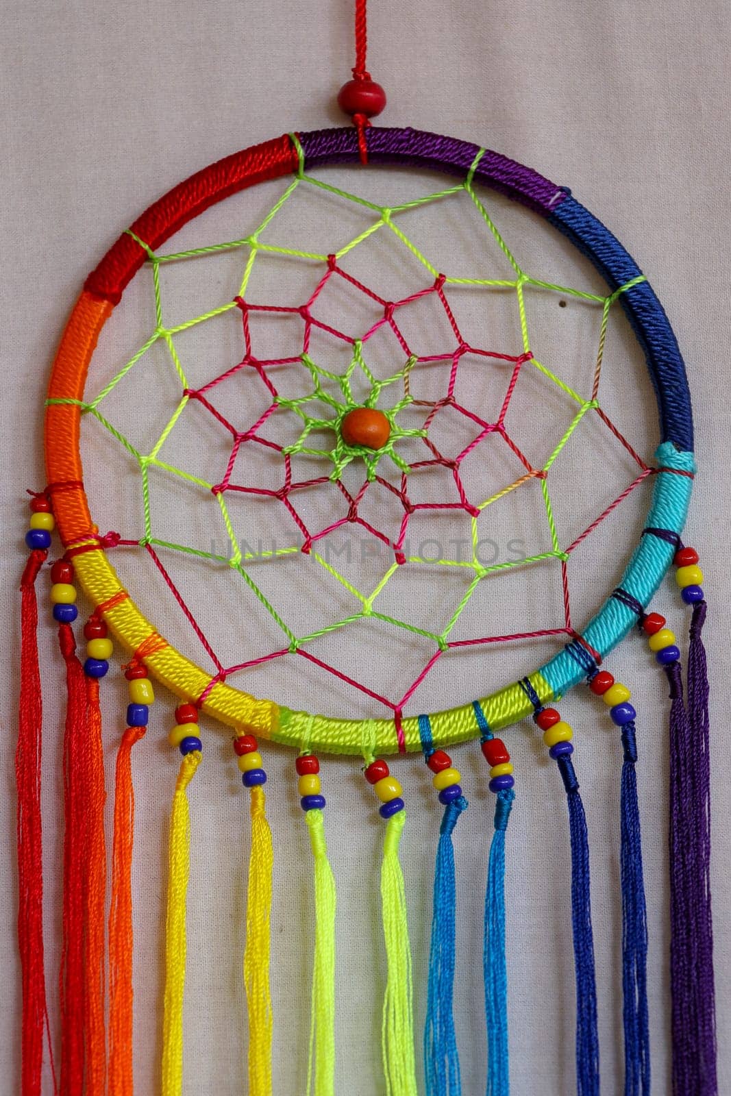 Beautiful multicolored handmade dreamcatcher on white background.