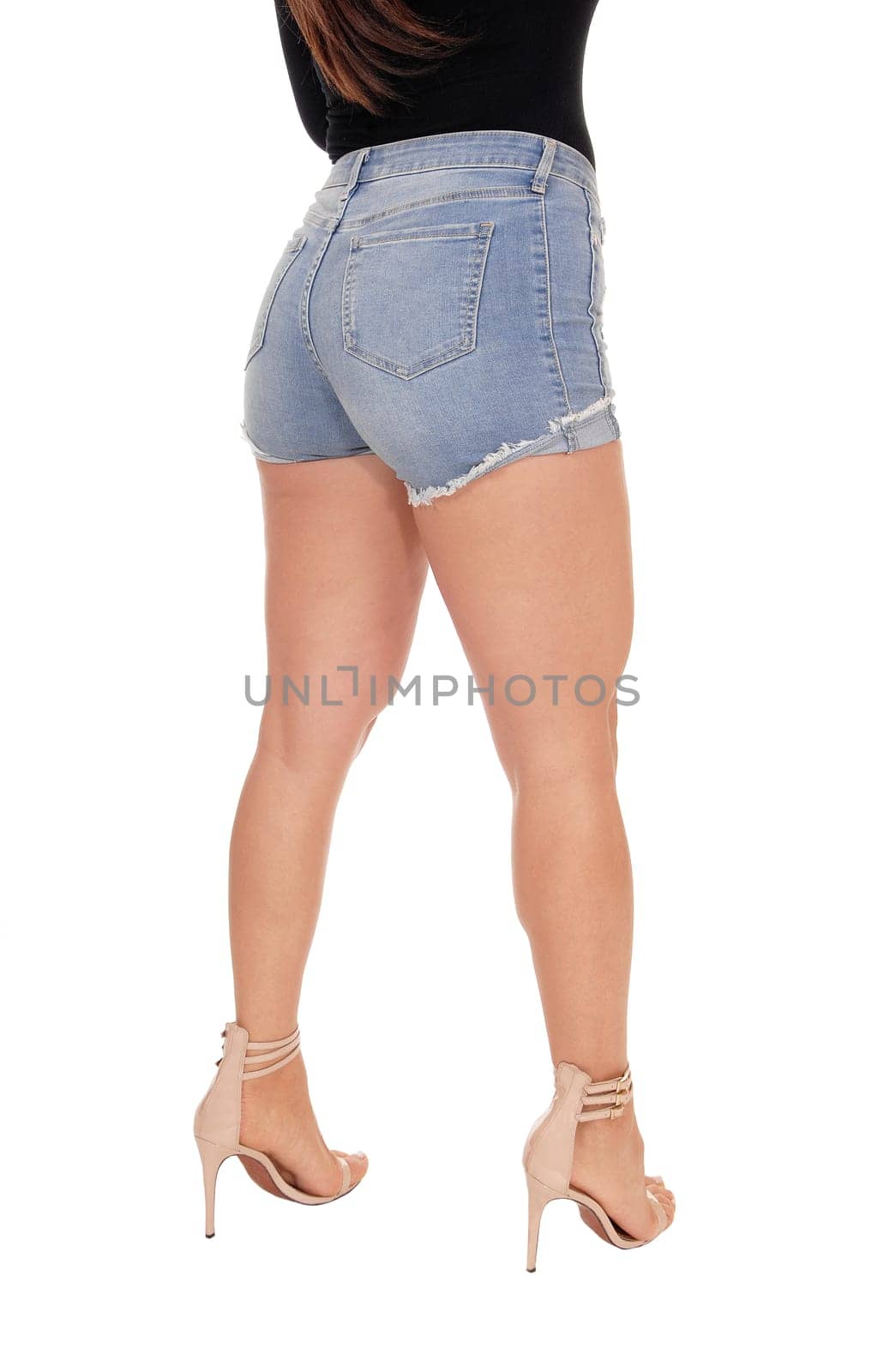 A young beautiful woman standing from the back in jeans shorts,.in body part, showing her nice figure, isolated for white background.