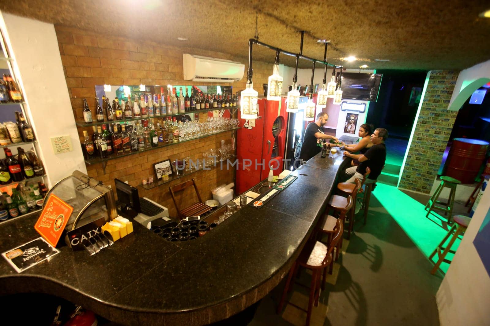 salvador, bahia / brazil - march 2, 2017: people are seen at a bar counter in the city of salvador