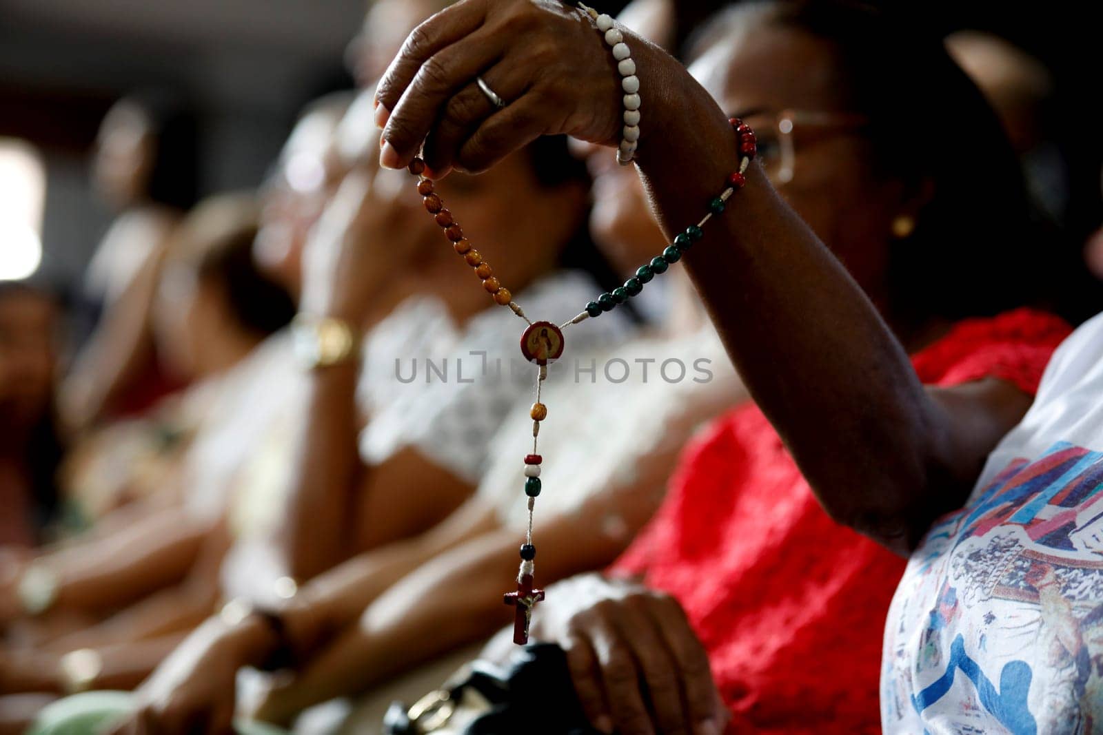 salvador, bahia / brazil - march 19, 2019: person holding religious rosary during mass at the Irma Dulce sanctuary in the city of Salvador.