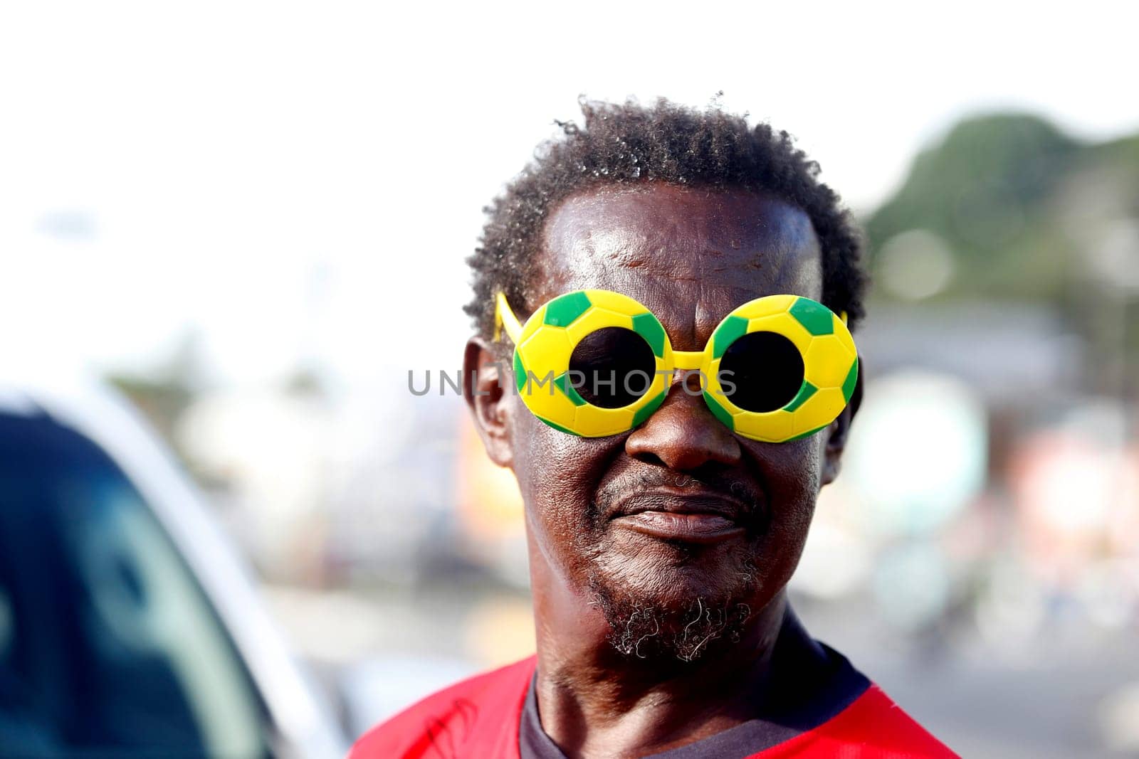 salvador, bahia / brazil - may 9, 2018: man is seen wearing soccer ball-shaped glasses in the city of Salvador.