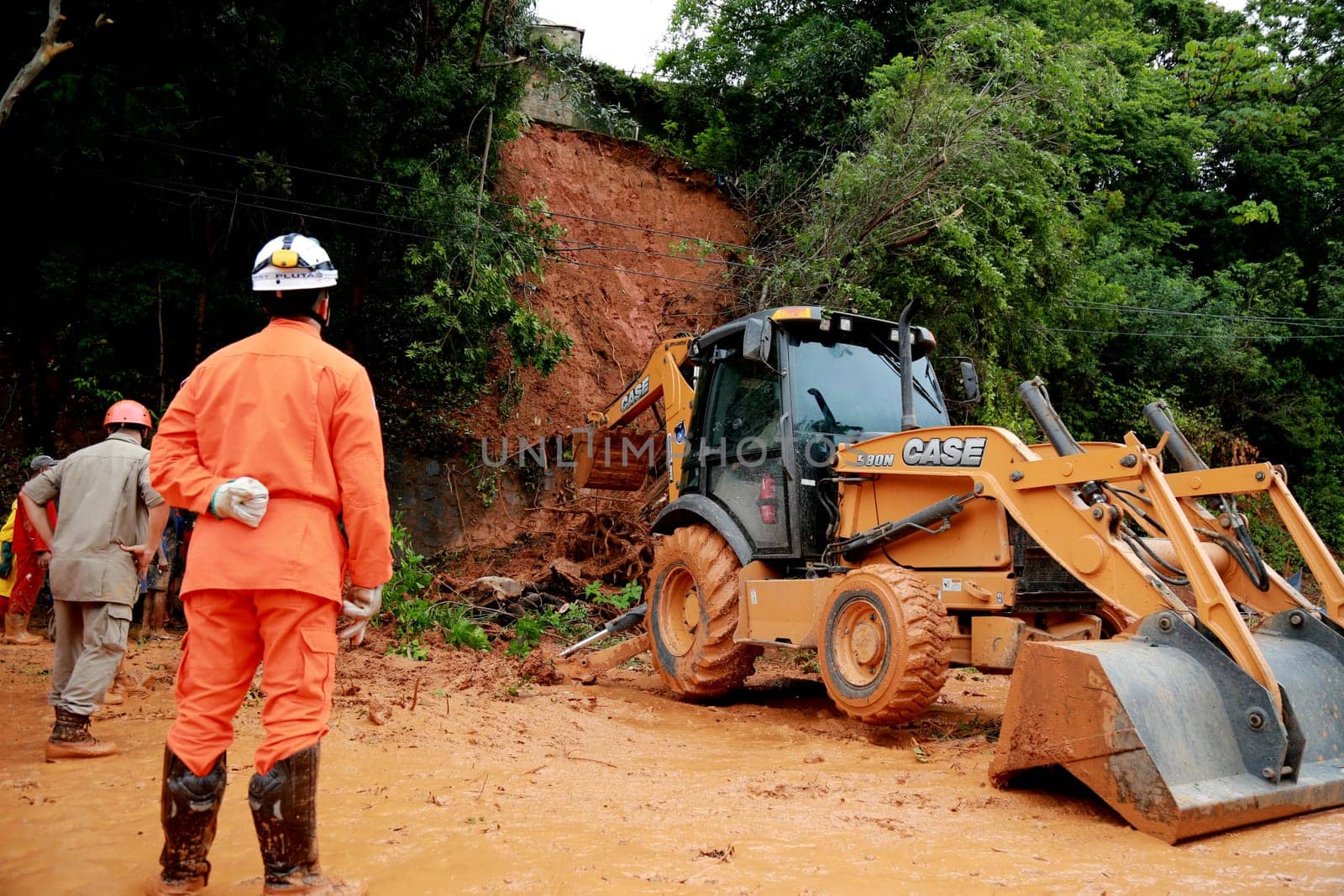 salvador, bahia / brazil - april 9, 2015: members of the fire department and volunteer people are seen during excavation of land that slid from a slope in the city of Salvador. the group seeks victims in the middle of the earth....