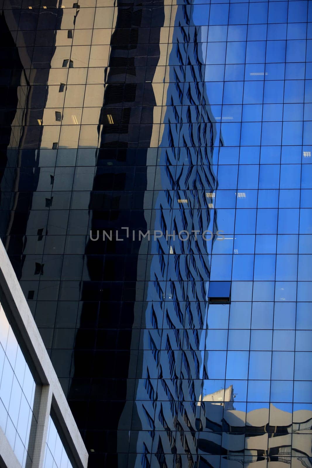 salvador, bahia / brazil - september 23, 2015: reflections of the street are seen in a mirrored building in the city of Salvador.